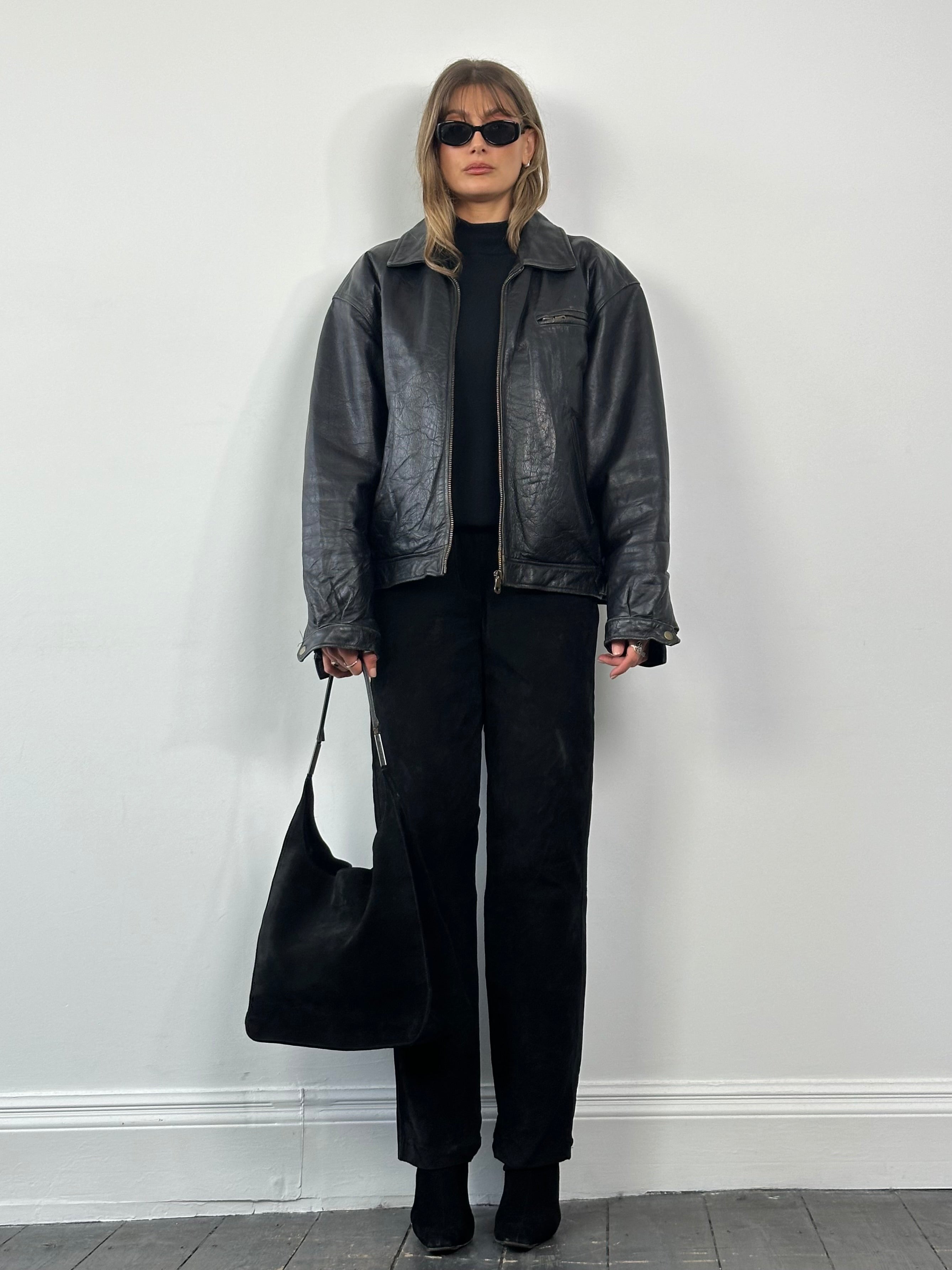 Vintage leather jacket in size XL, featuring classic design and authentic leather texture, displayed on a neutral background.