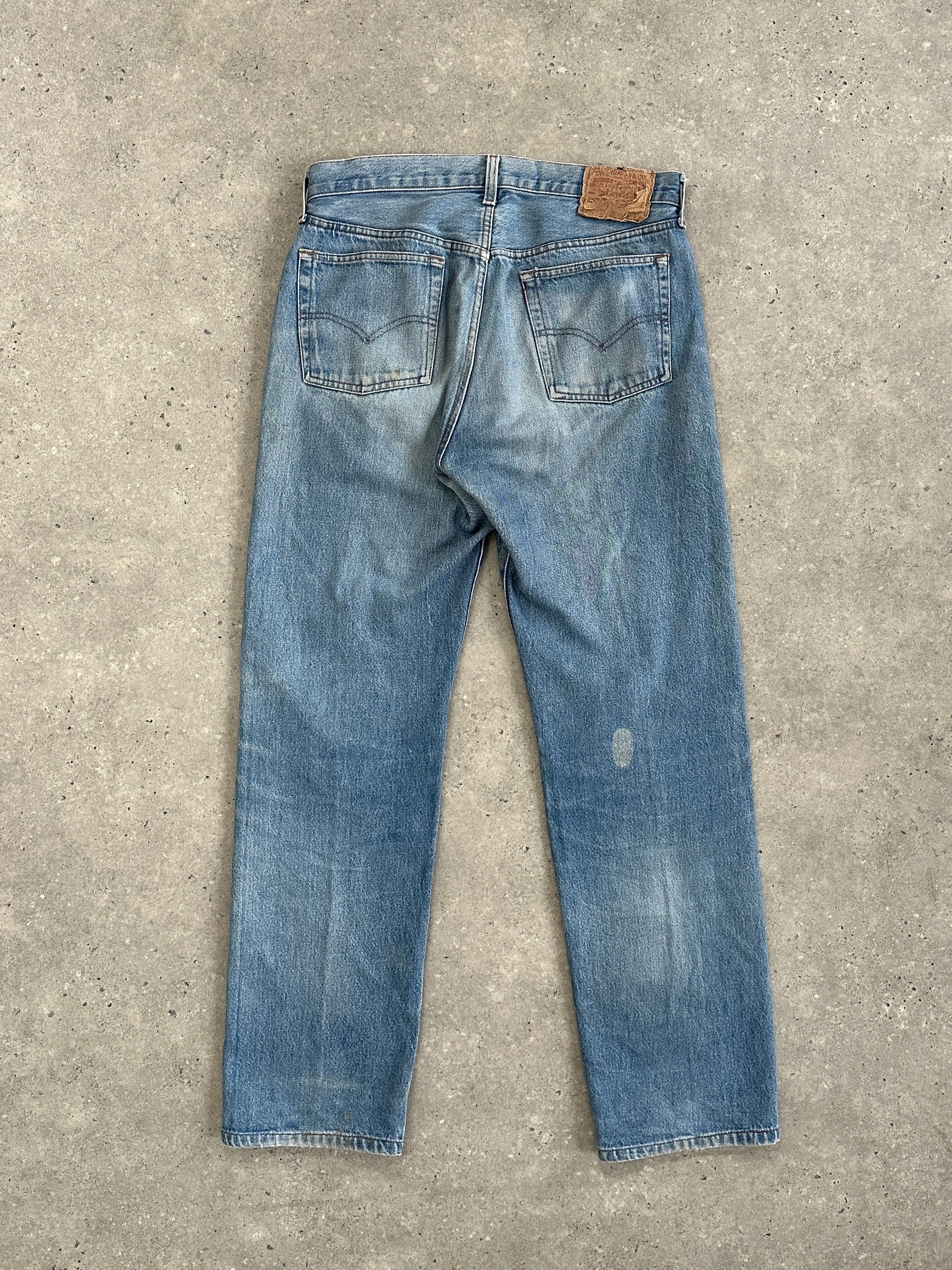 Levi's 501 straight leg denim jeans in W32, showing classic blue jeans with button fly and timeless fit.