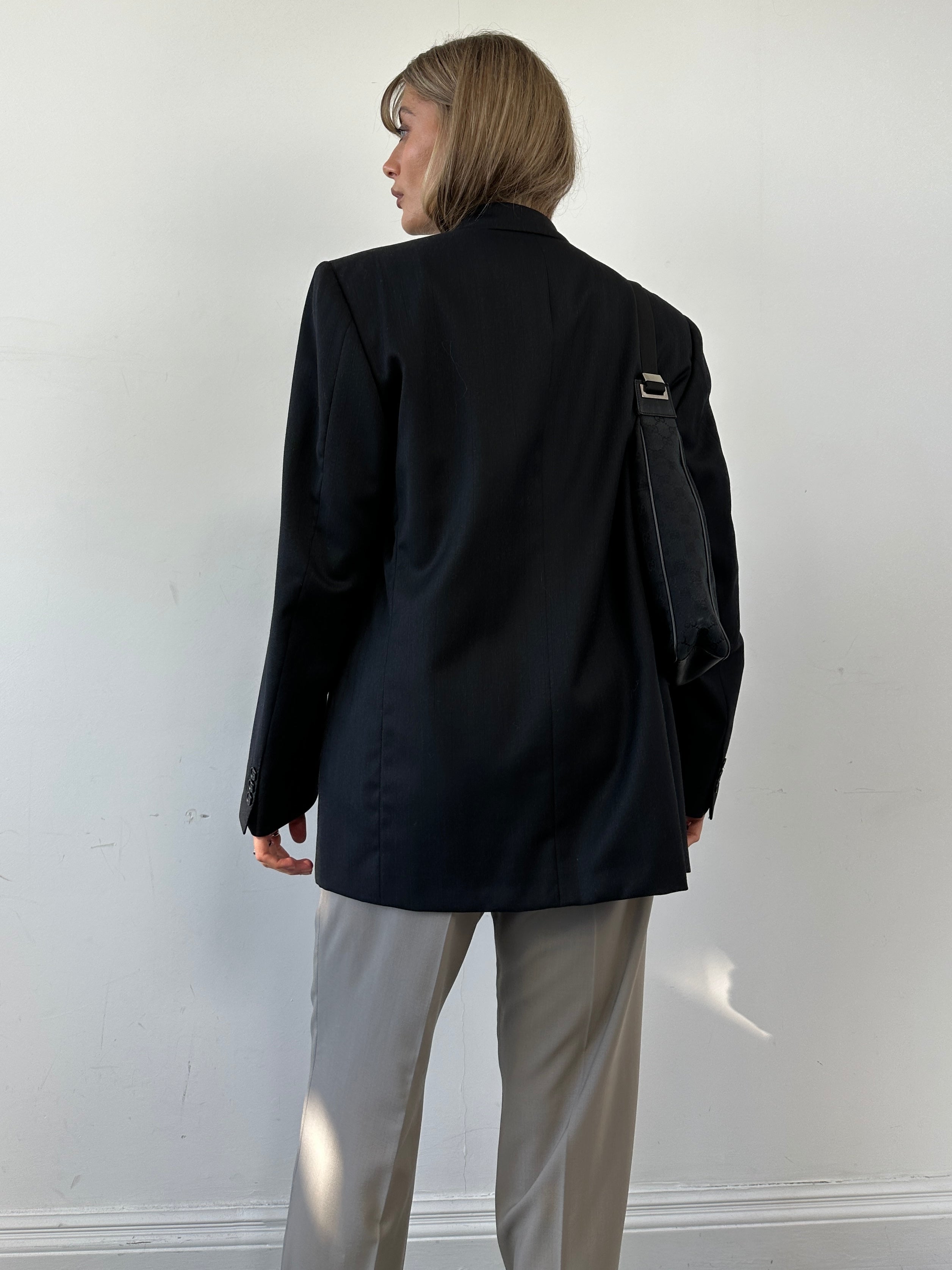 Pal Zileri oversized double-breasted blazer with wide lapel, tailored fit, in a stylish dark fabric, shown on a hanger.