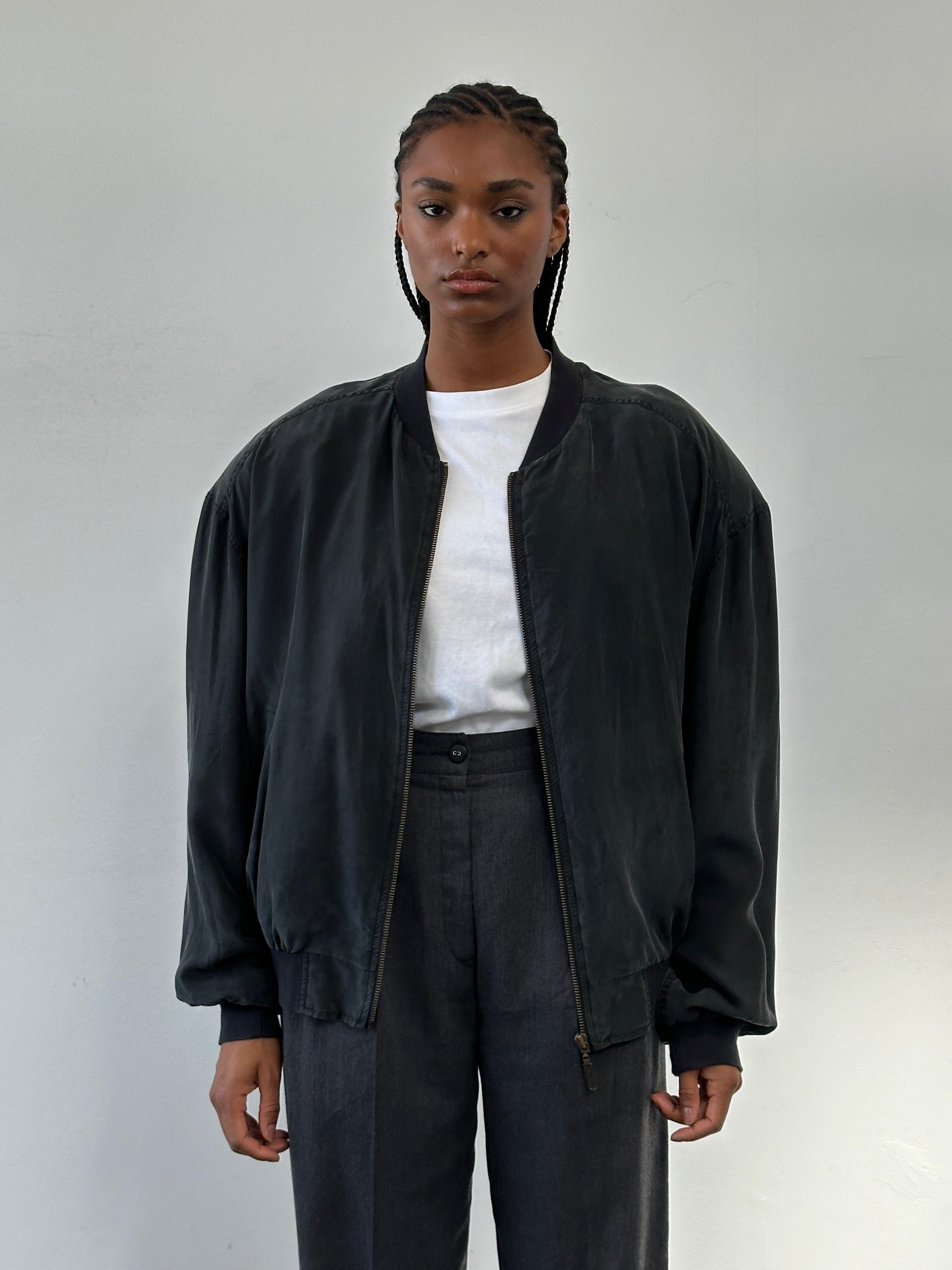 Vintage 1990s pure silk bomber jacket, size large, featuring a classic style with a smooth, shiny fabric and ribbed collar.
