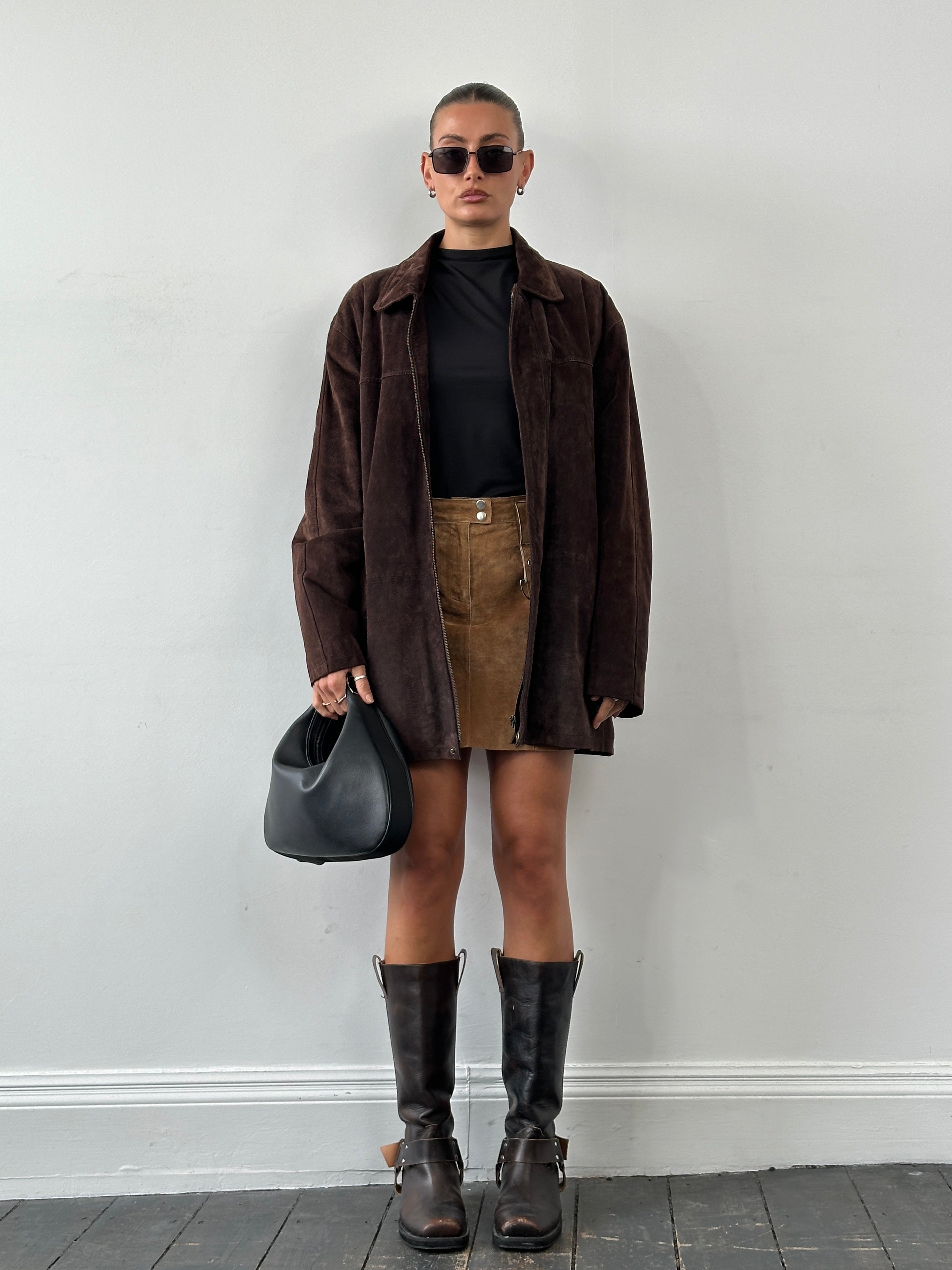 Balmain XL mid-length suede jacket displayed on a hanger, showcasing its stylish design and soft suede texture.