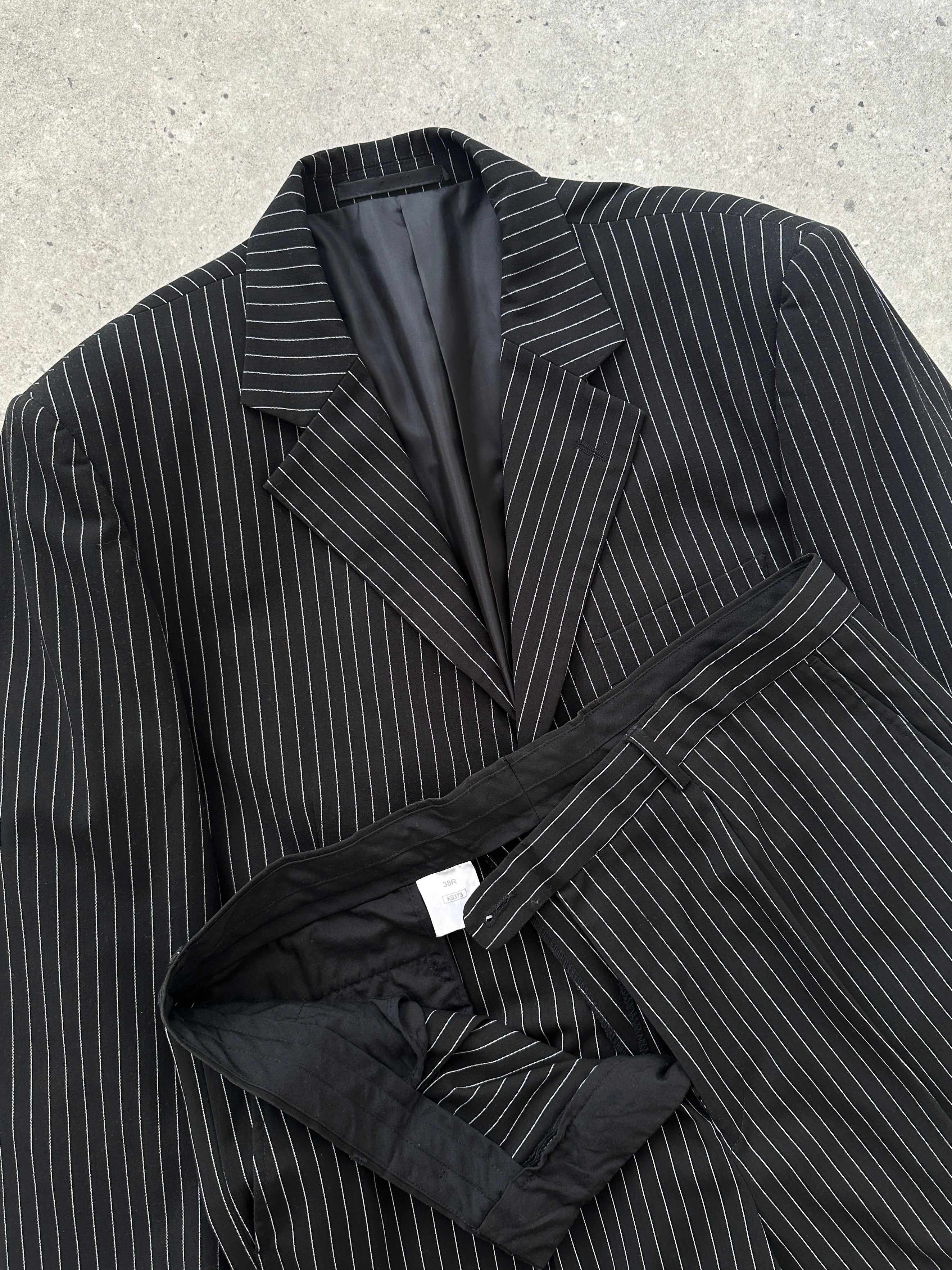 Vintage pinstripe single-breasted suit jumpsuit in size 40R/W36, featuring classic tailoring and vintage-style pinstripe fabric.