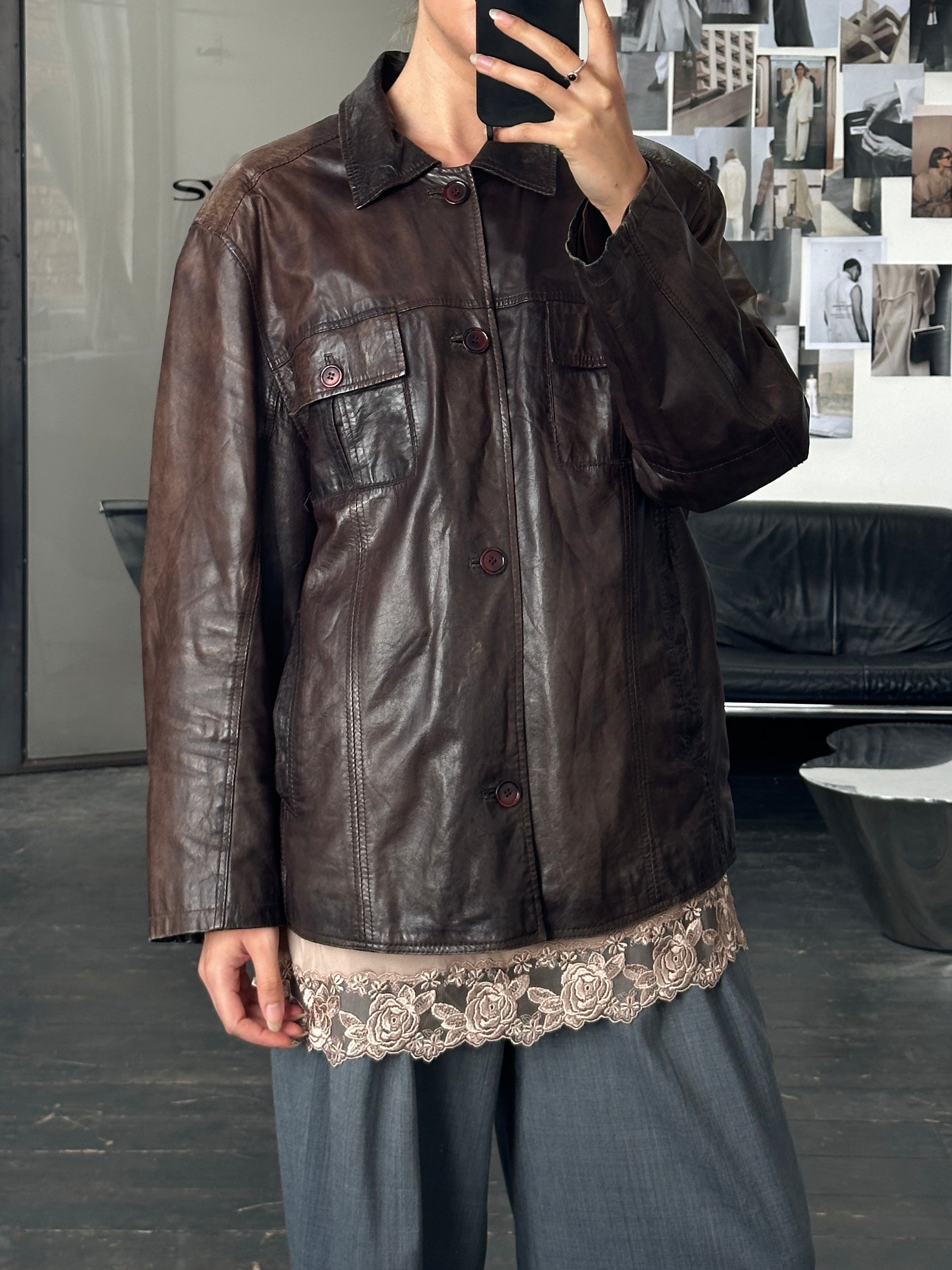 Vintage 1990s aged leather jacket in size XL, featuring distressed brown leather with classic collar and metal button details.