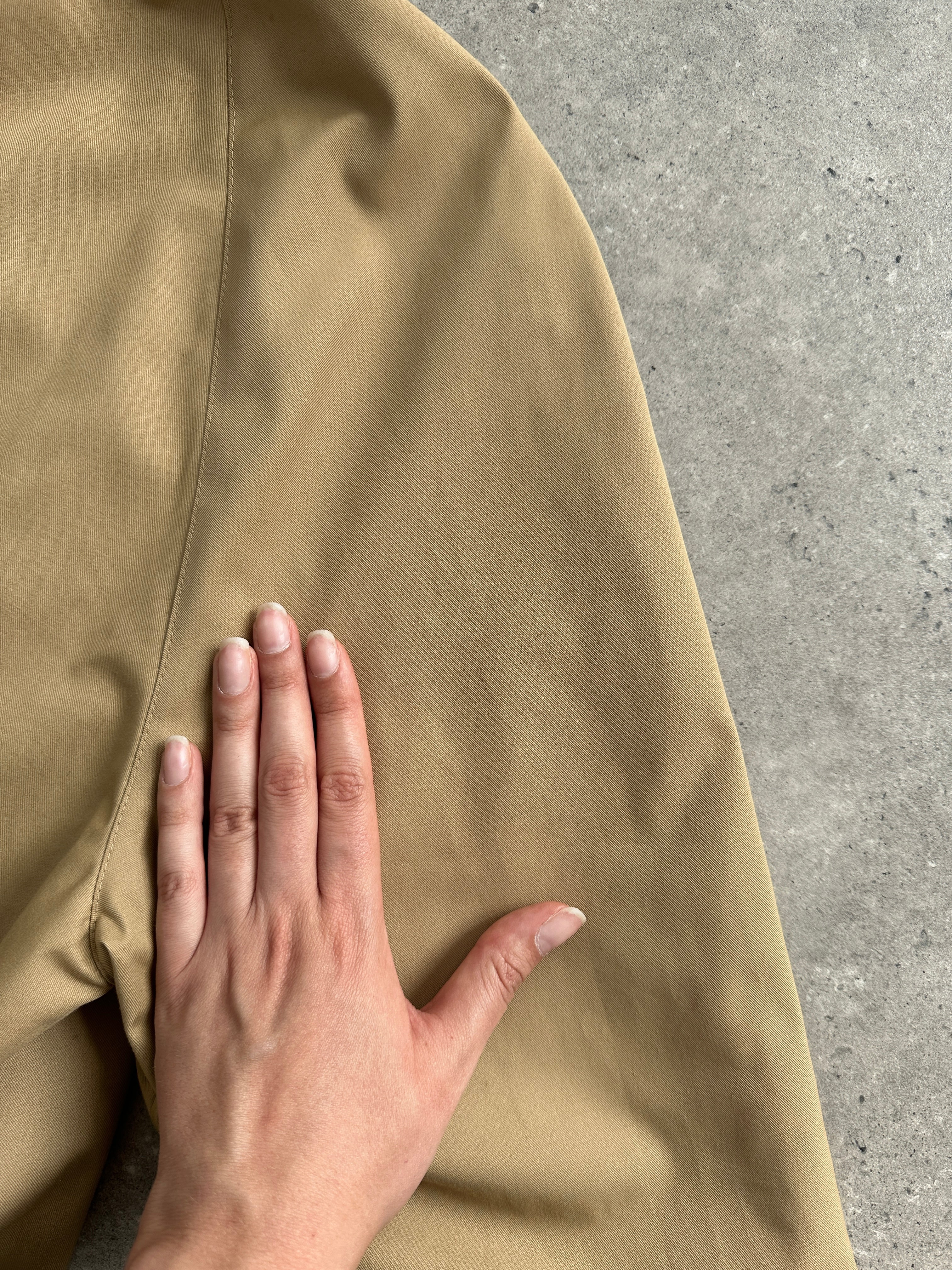 Vintage XL trench coat with concealed placket, belted waist, classic design, and lightweight fabric.