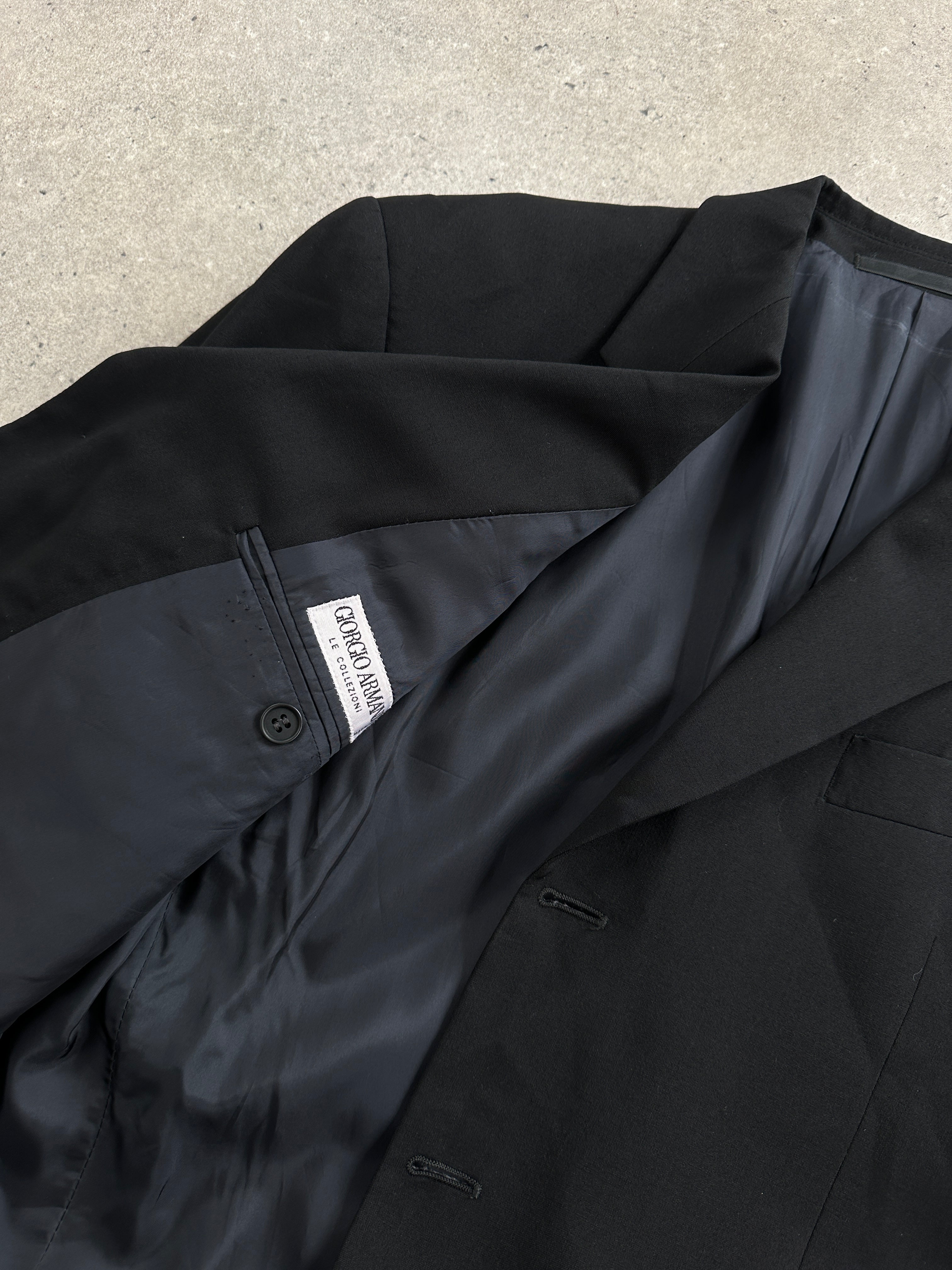 Giorgio Armani Le Collezioni 1990s wool single-breasted blazer in size 40R/M, shown on a hanger with classic tailoring details.