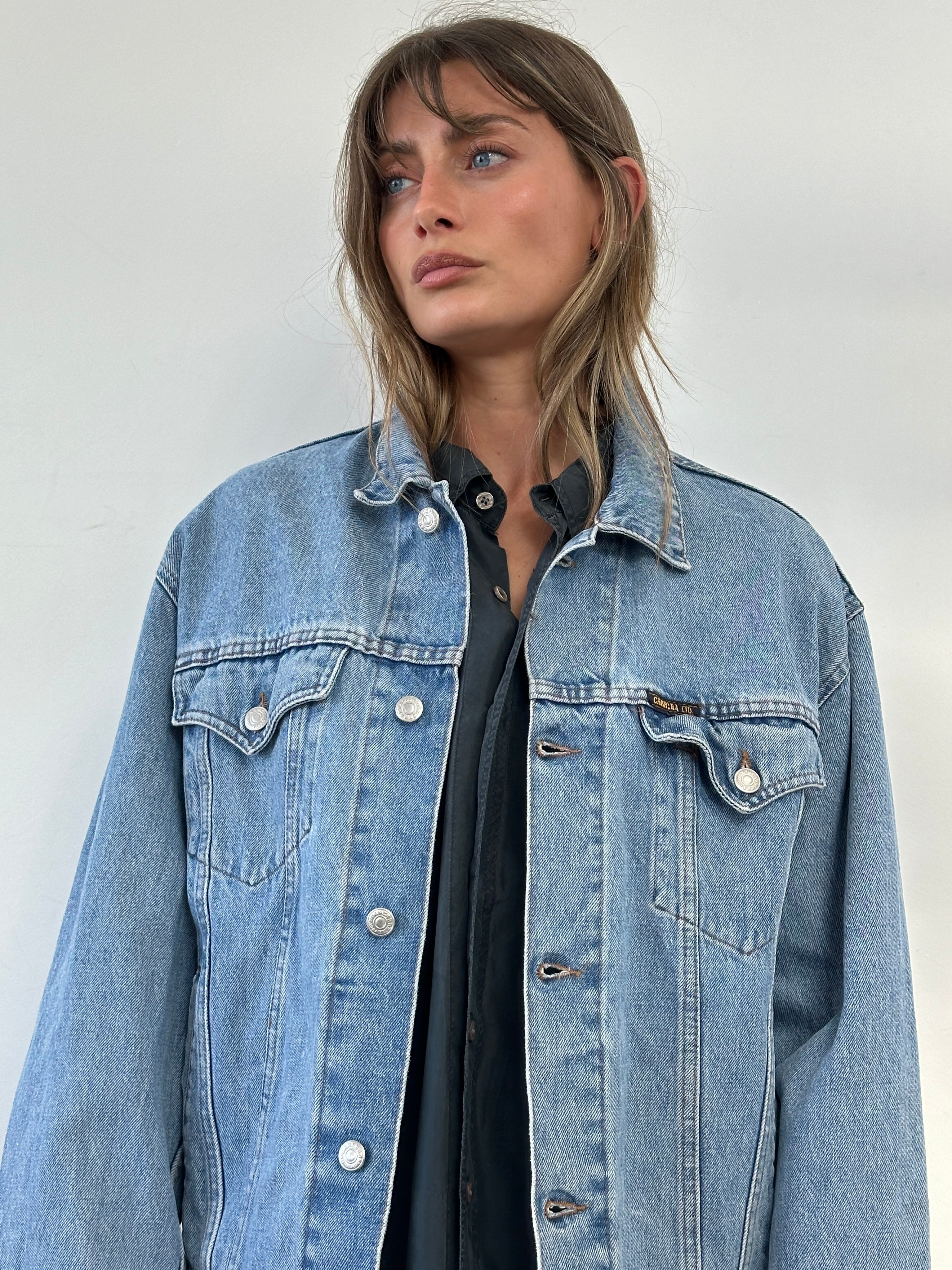 Carrera Italian oversized denim jacket from the 80s-90s featuring classic blue denim and relaxed fit, size large.