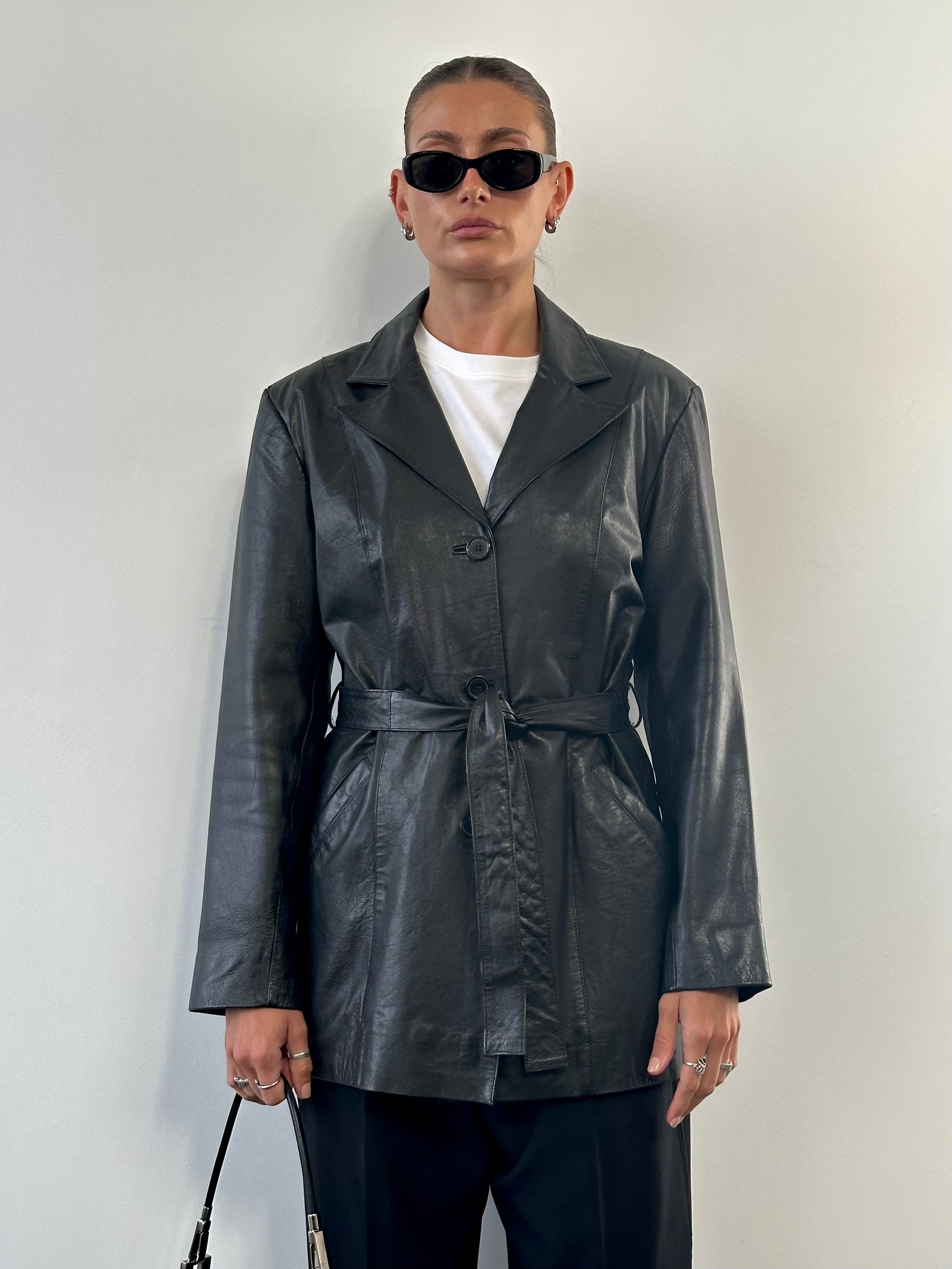 Vintage leather belted jacket in size M/L, stylish and classic leather jacket with buckle details and rugged texture.