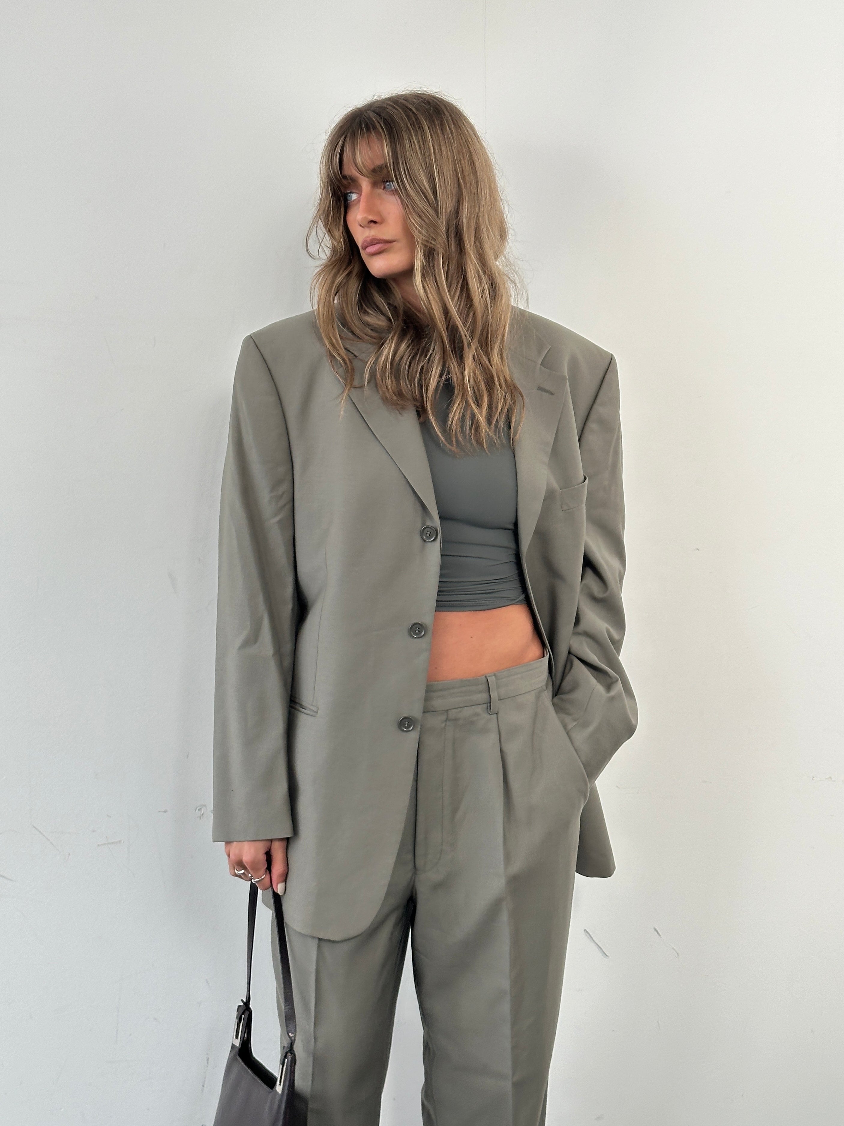 Pierre Cardin pure wool single-breasted suit jumpsuit in size 40R/W33, tailored fit, with lapel collar and front buttons.