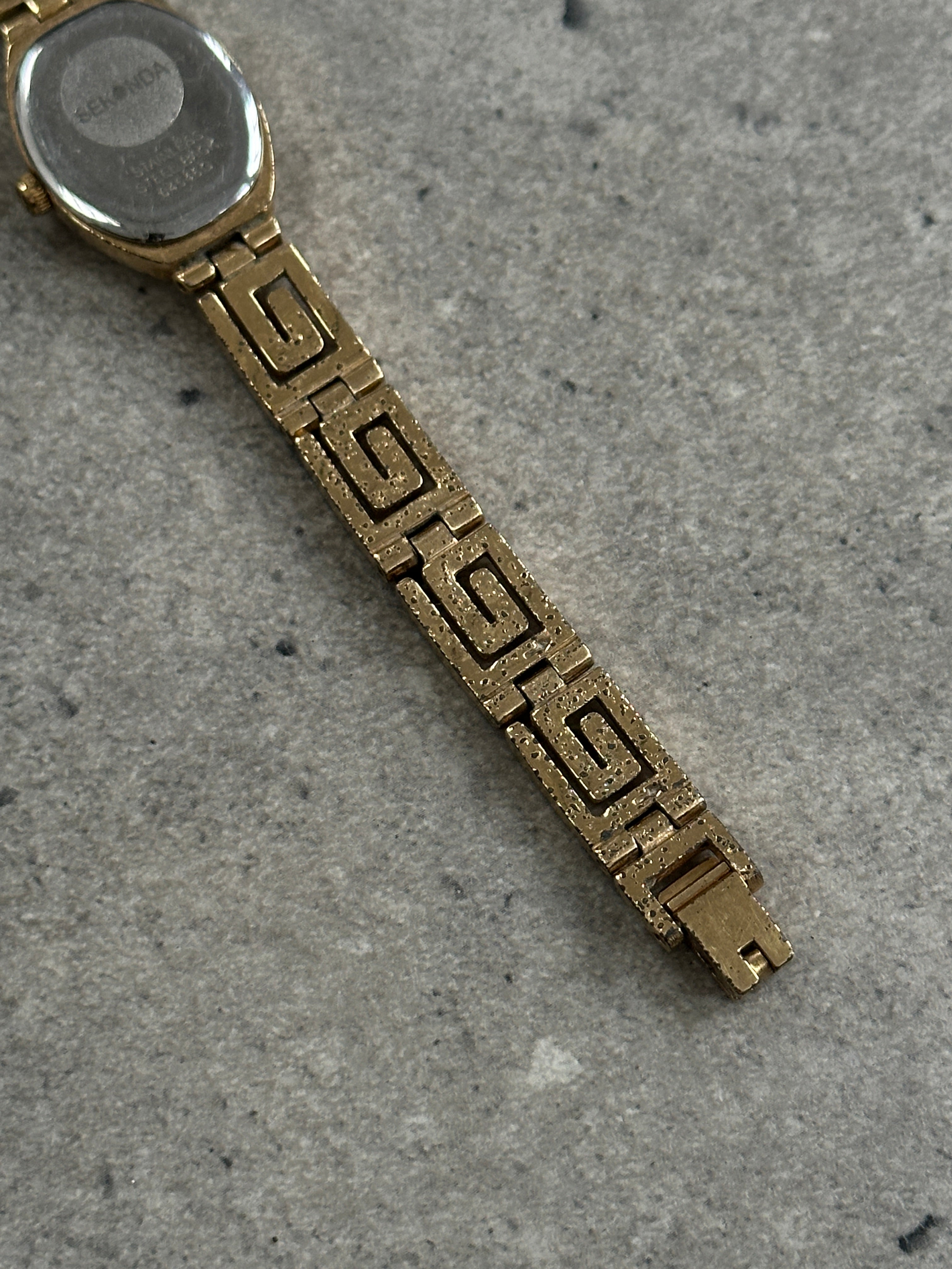 Sekonda 1990s oval gold-tone geometric quartz watch with sleek design and classic style, featuring a gold-colored dial and bracelet.