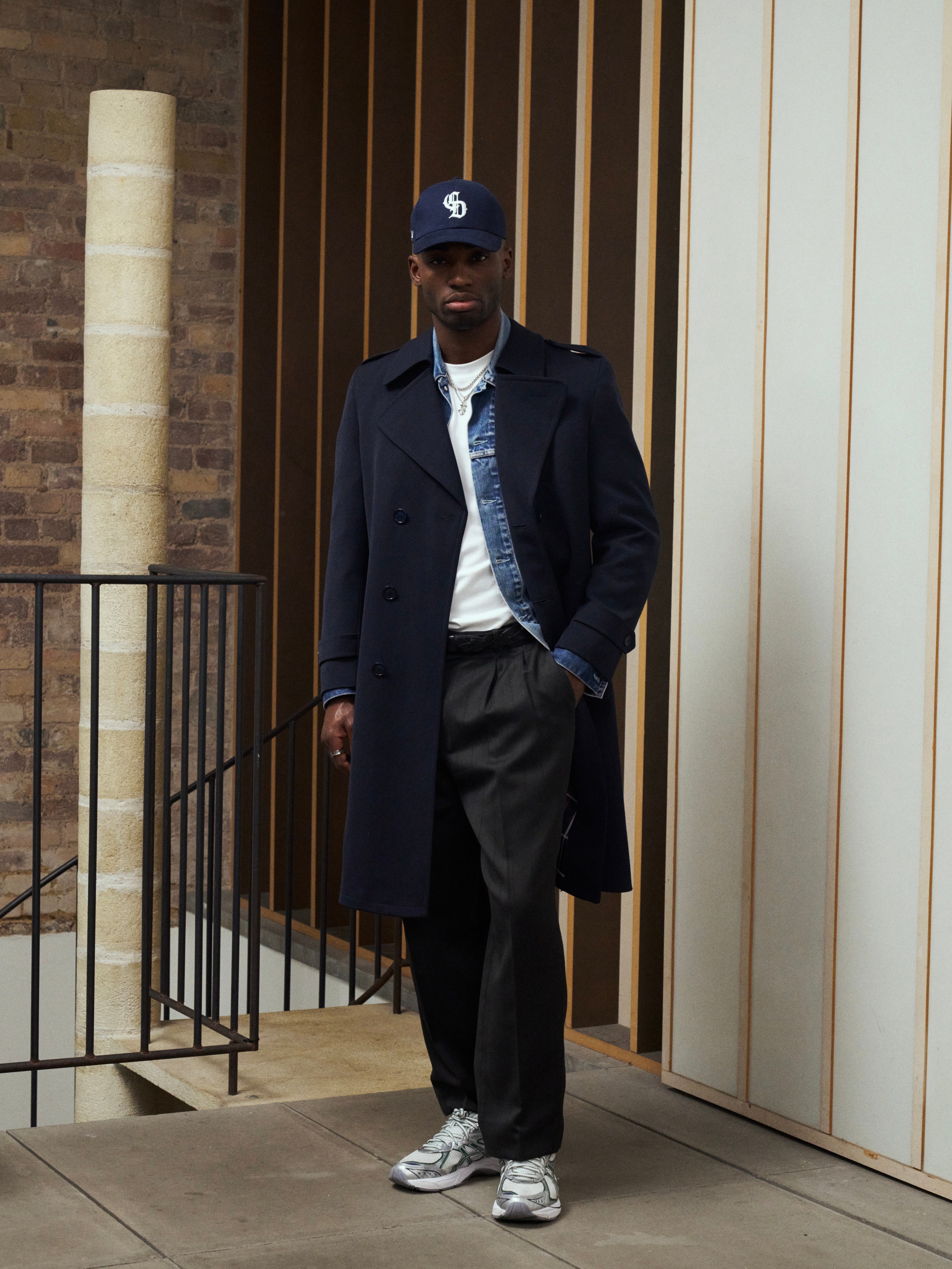 Vintage brand wool twill belted trench coat in XL, shown hanging with classic double-breasted design and neutral color.