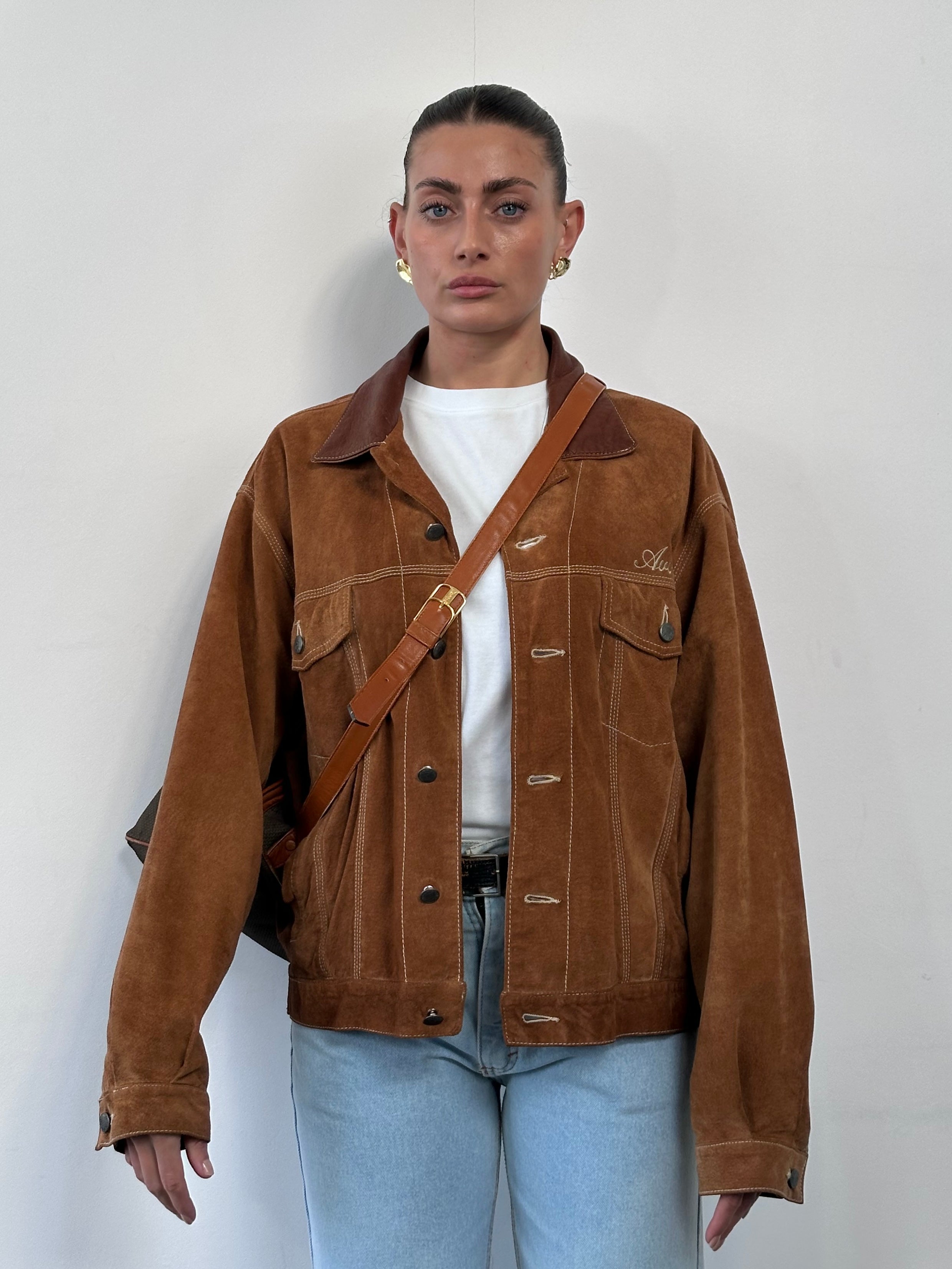 Avirex suede trucker jacket in size large, featuring a classic design with a soft suede exterior and button-front closure.