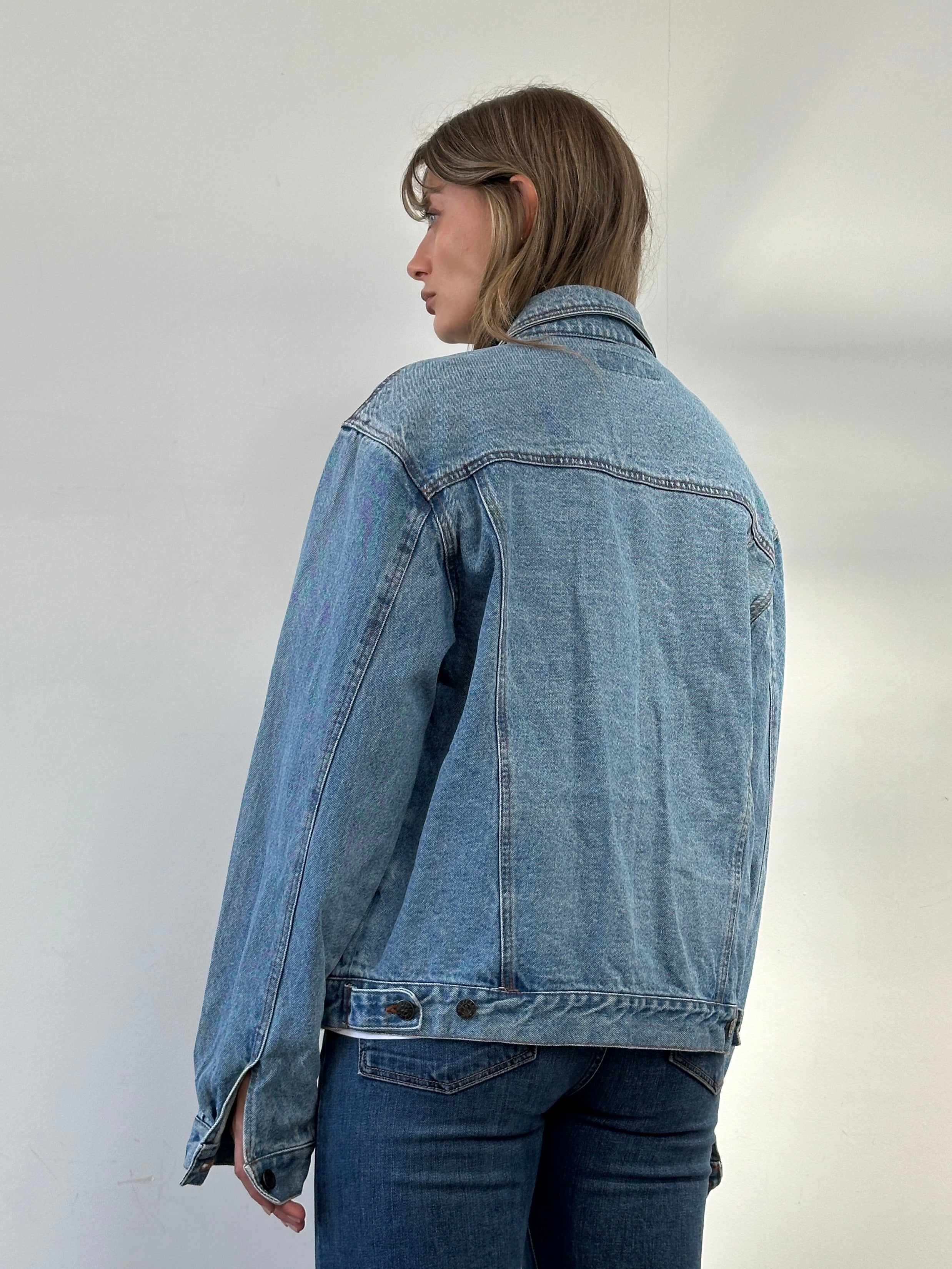 Vintage oversized pure cotton denim jacket with classic design, shown in a natural light on a model.