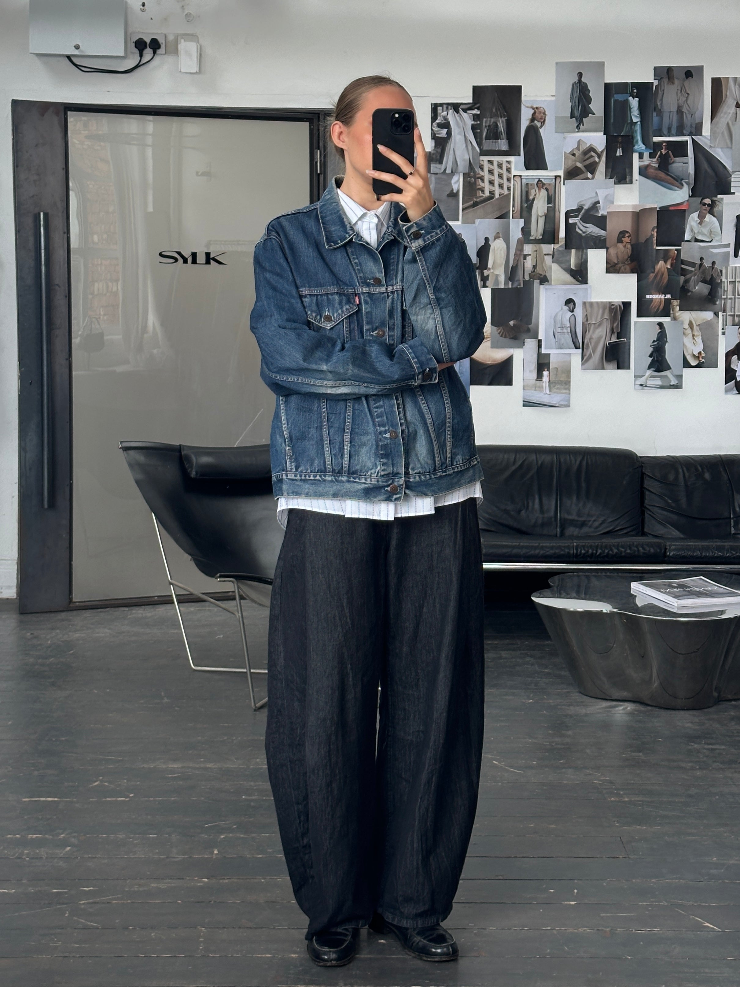 Levi’s 1990s mid wash denim jacket with button front and classic fit, displayed on a hanger.