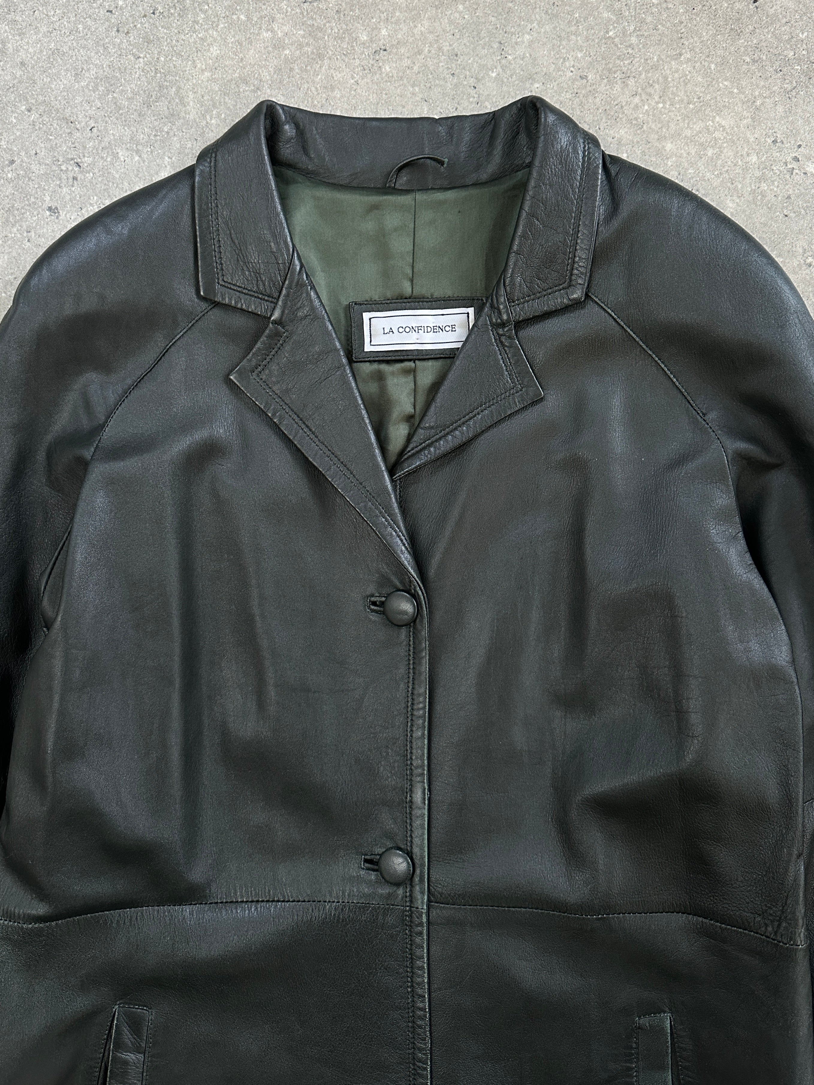 Vintage 1990s floor-length leather trench coat jacket, stylish vintage outerwear with classic design and rich leather texture.