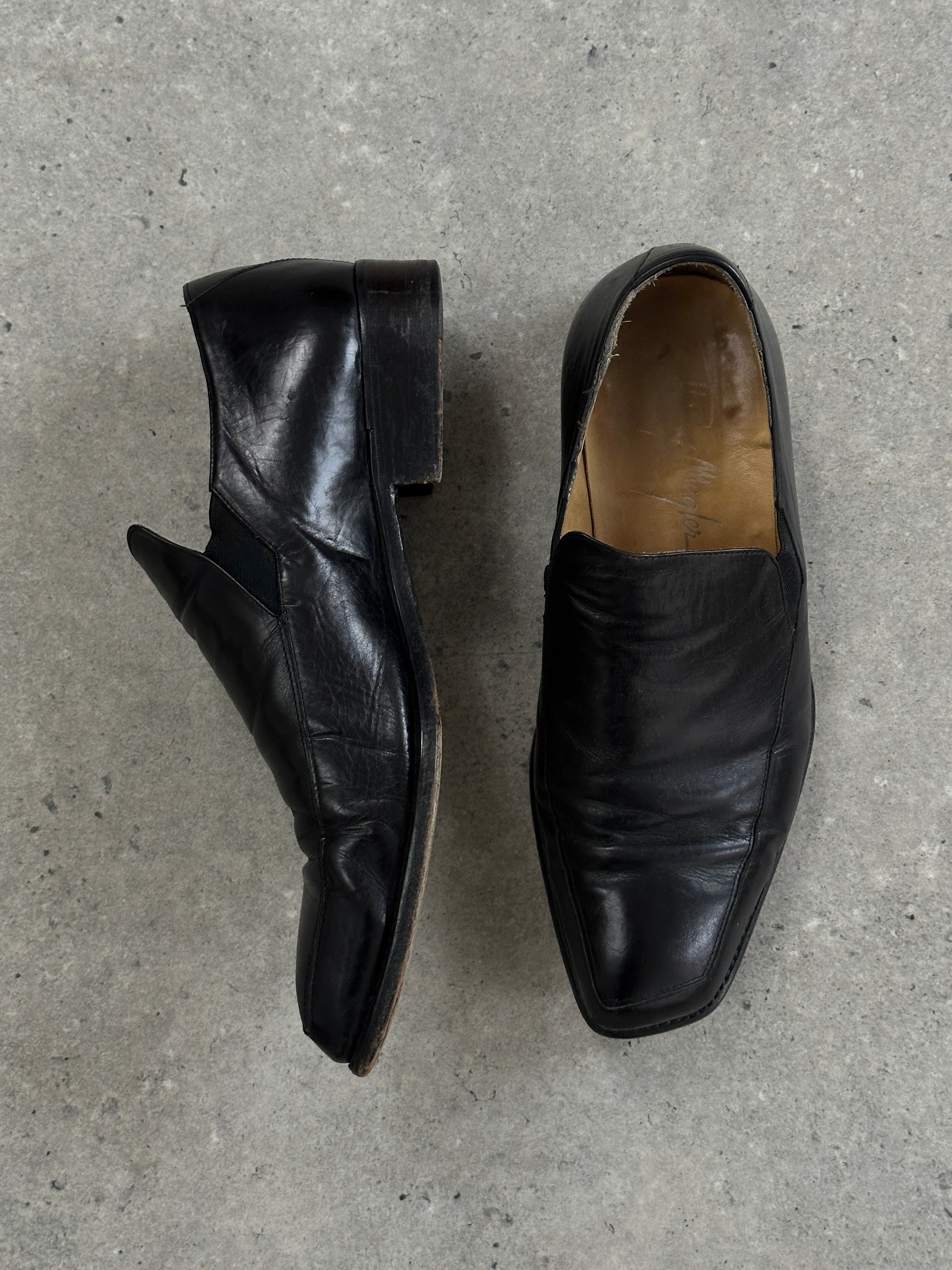 Thierry Mugler 1990s leather angular toe shoes in black, UK8/9, with sleek design and pointed toe, on a white background.
