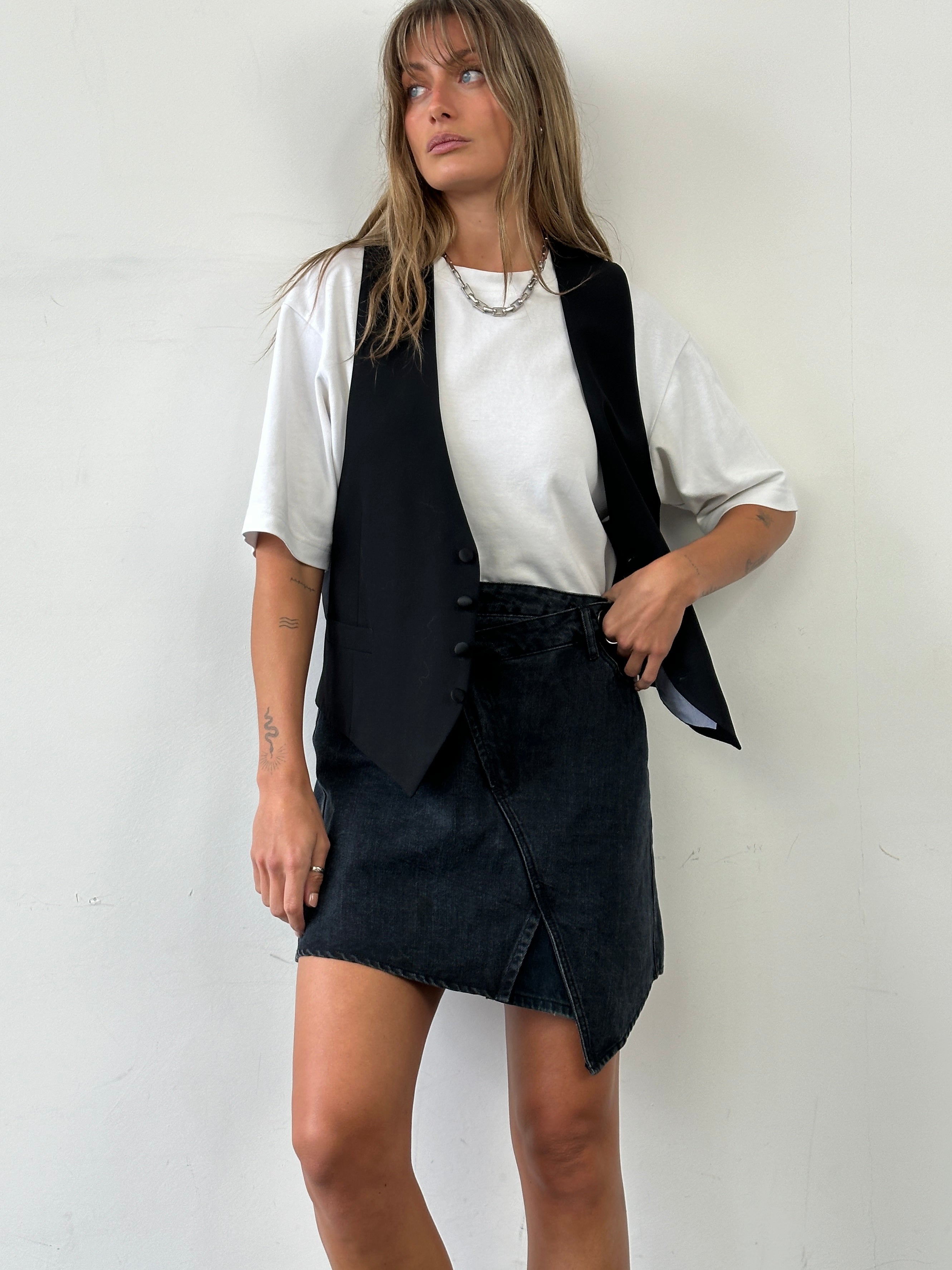 Vintage asymmetrical denim mini skirt with distressed details, front and back views, W32 size, casual trendy style.