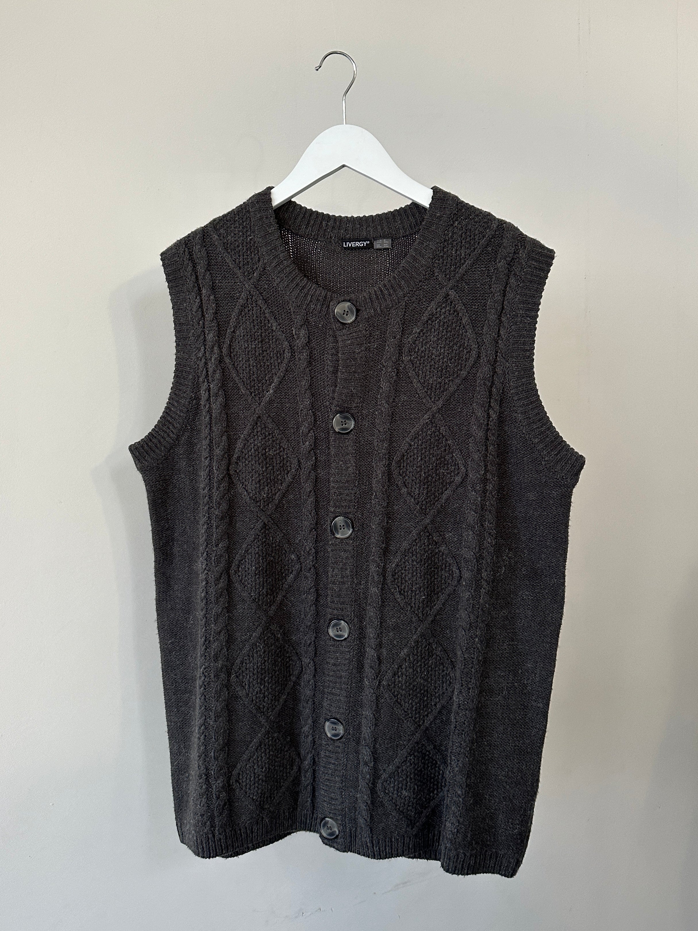 Vintage brand cable knit sleeveless cardigan in size L/XL, beige color, showcasing its textured knit pattern and sleeveless design.