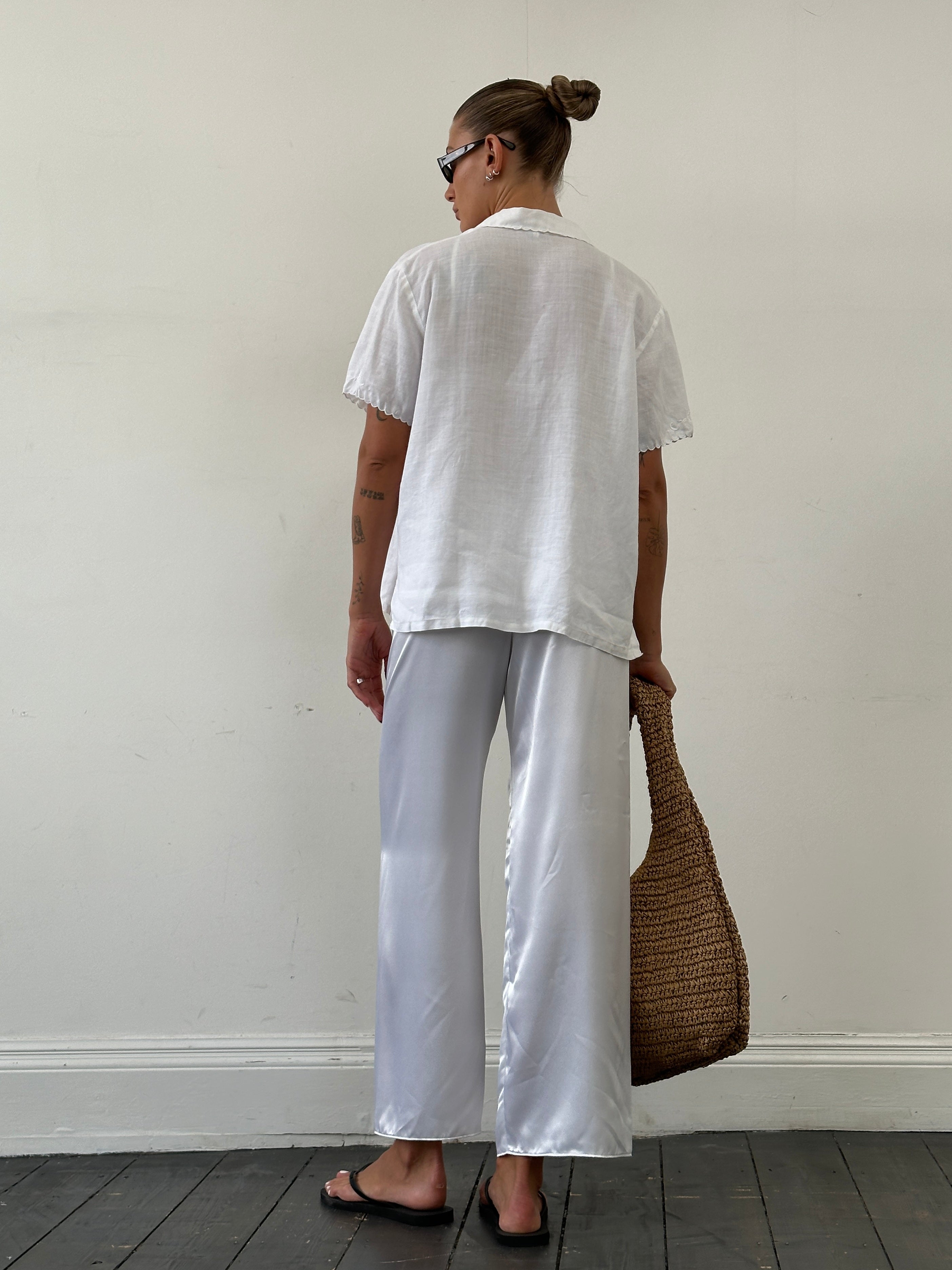 Vintage satin elasticated straight leg trousers in W25-28, shown on hanger with smooth fabric and classic fit.
