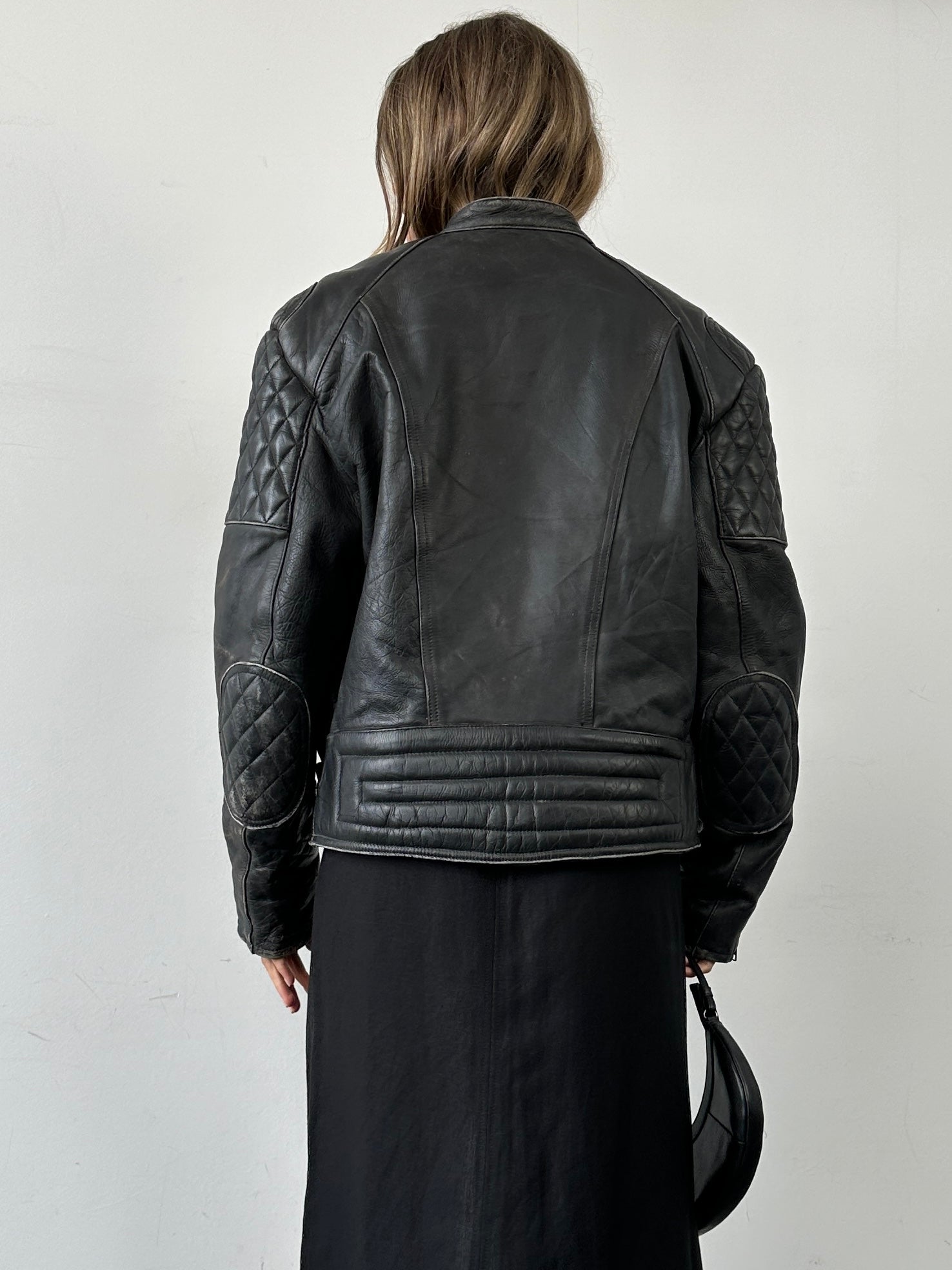 Vintage distressed motorcycle leather jacket in large/X-large size, featuring rugged design and classic style.