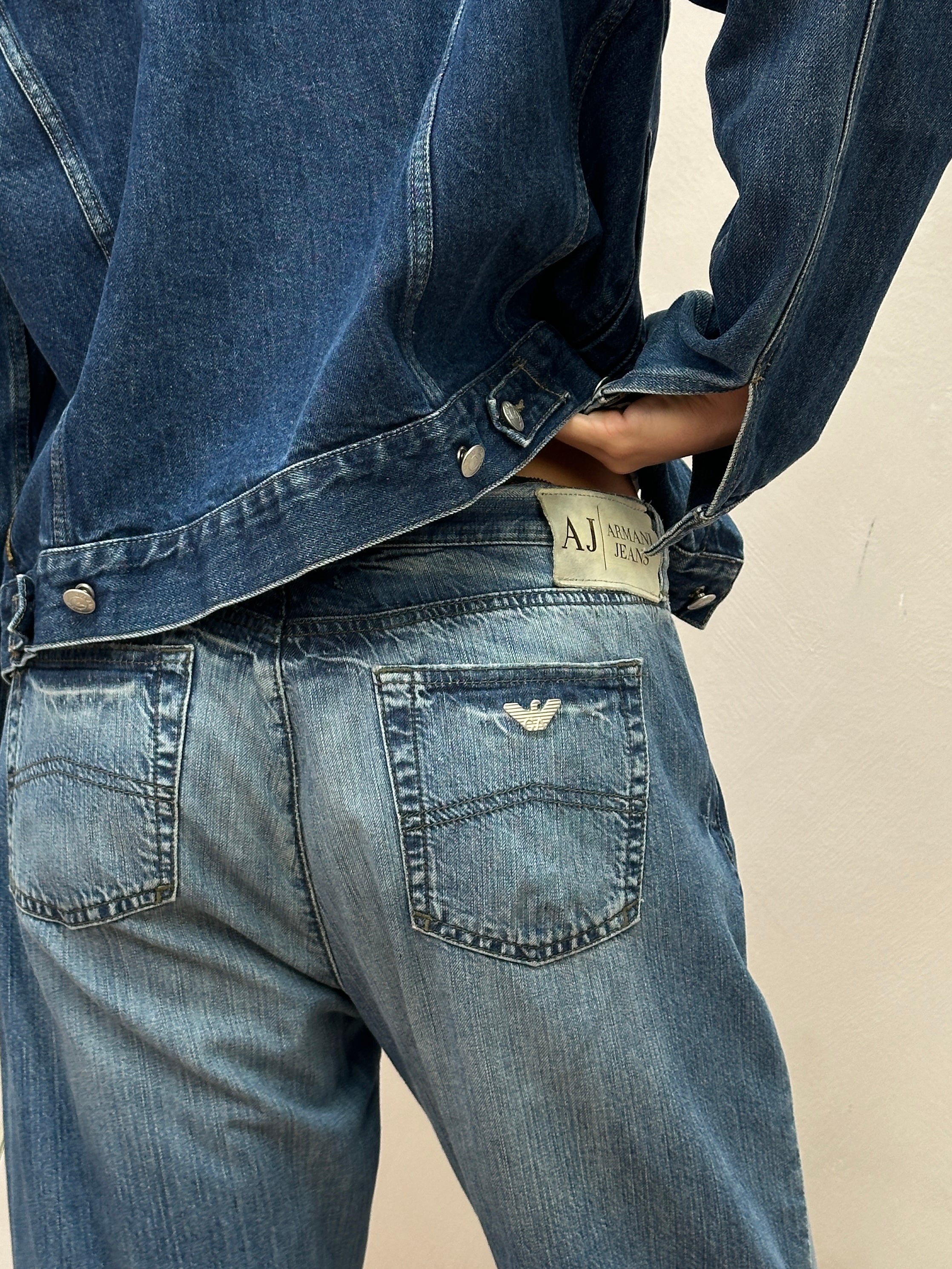 Armani Jeans stonewashed mid-waste denim jeans in W34, showcasing classic fit and faded blue fabric with five-pocket design.