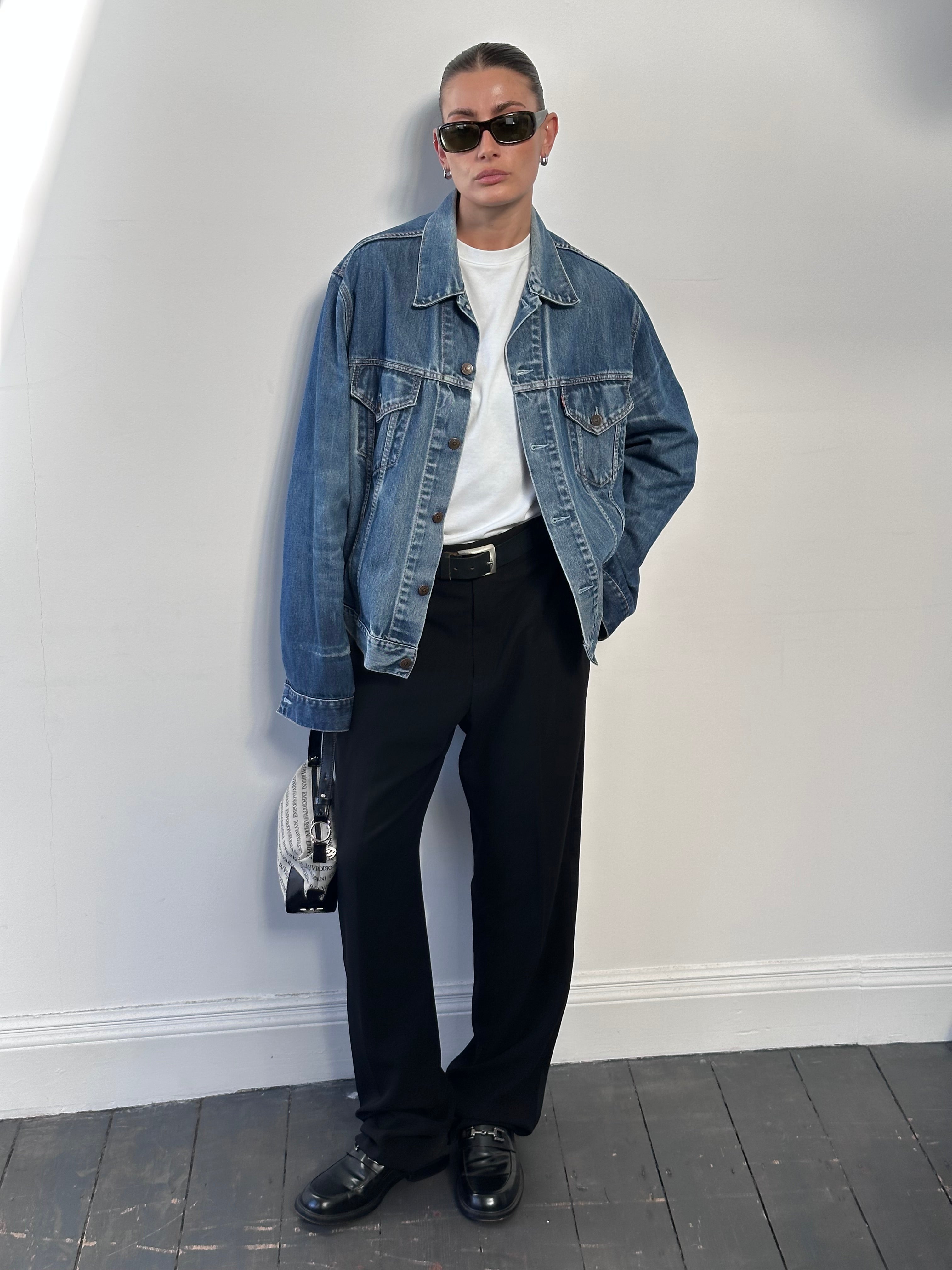 Levi’s faded denim jacket in size L, featuring classic style and distressed details, shown on a hanger.