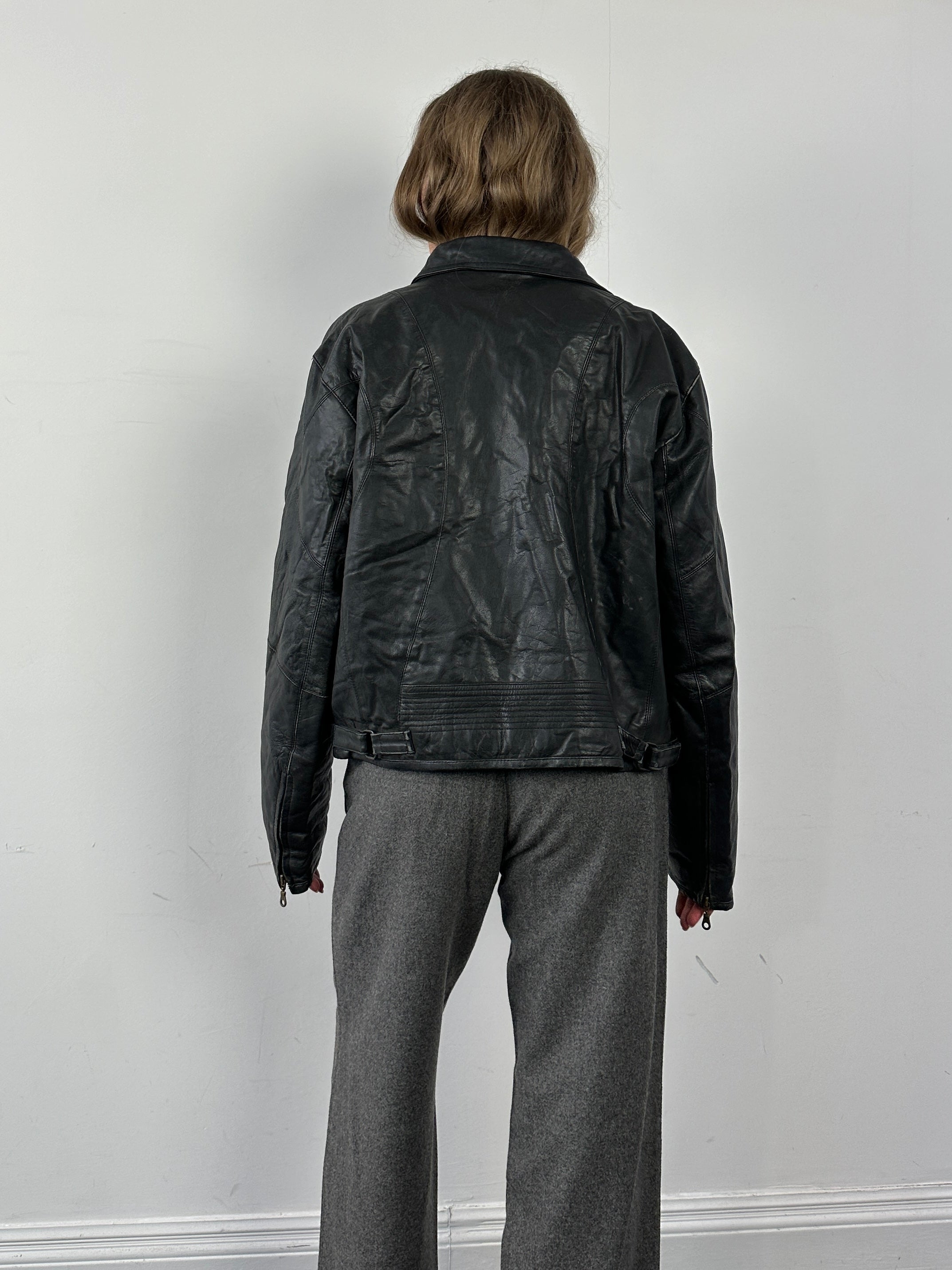 Conbipel leather jacket in size M/L, stylish black leather with classic collar and zipper detailing, worn by a model.