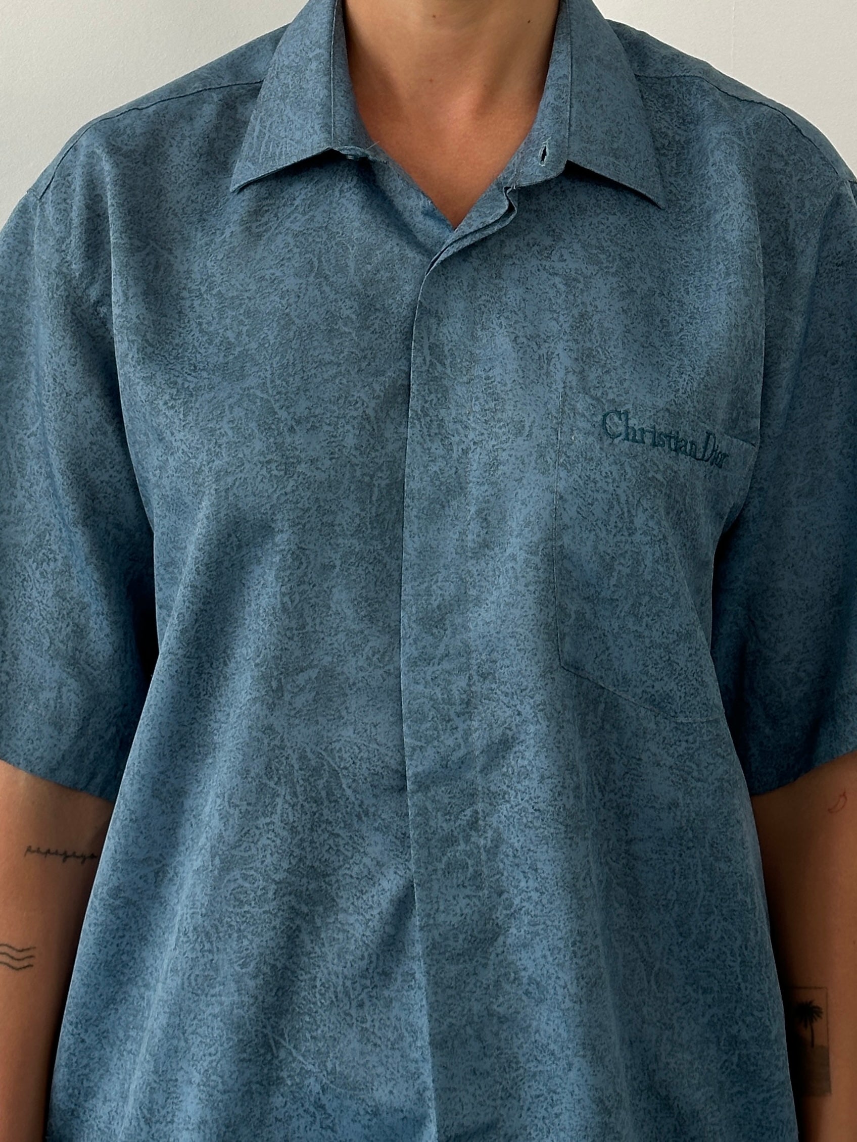 Christian Dior silk print short sleeve logo shirt in size L, featuring a stylish design and vibrant branding details.