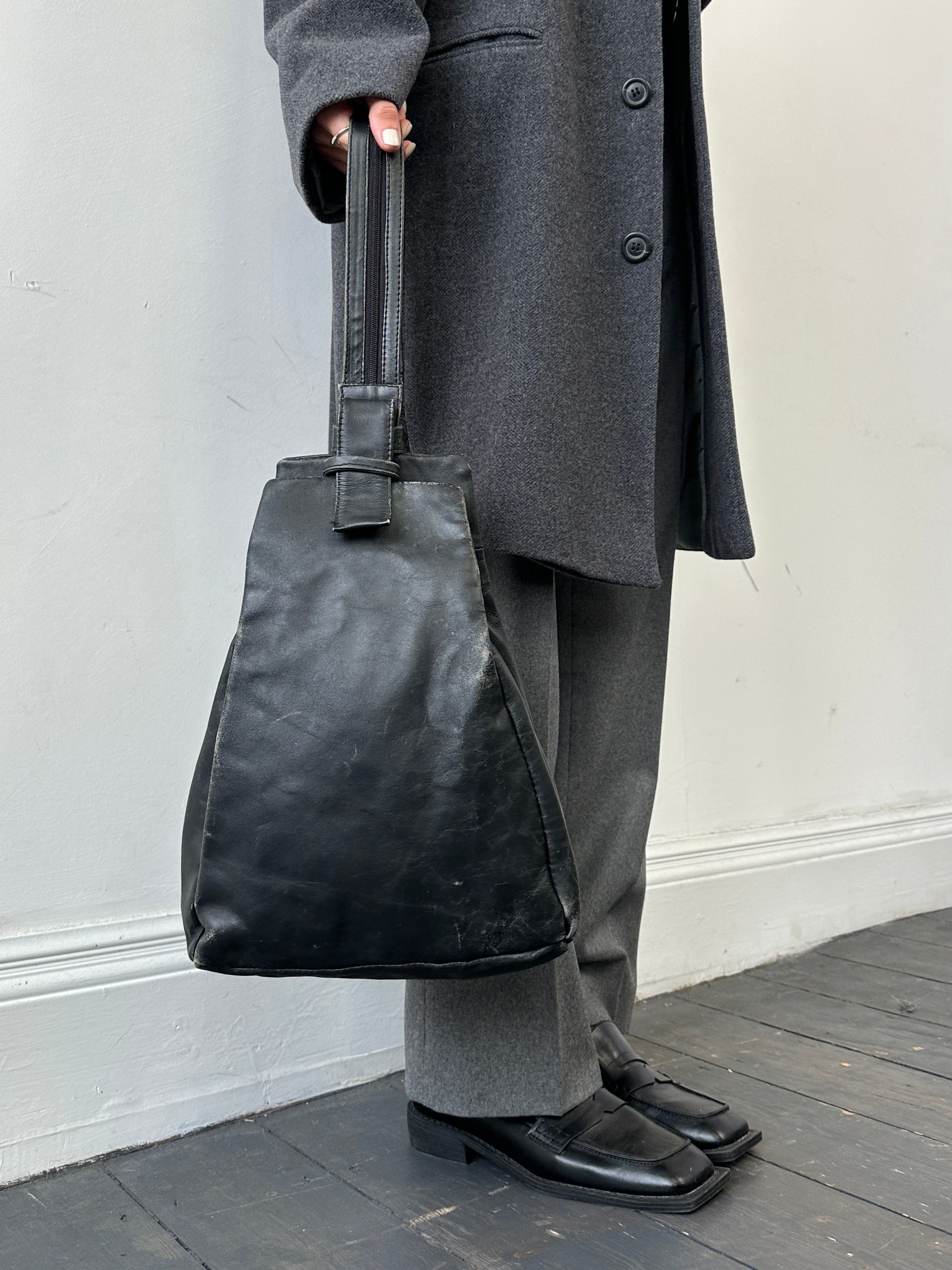 Vintage distressed faux leather rucksack crossbody bag with adjustable strap and vintage design, perfect for casual wear.