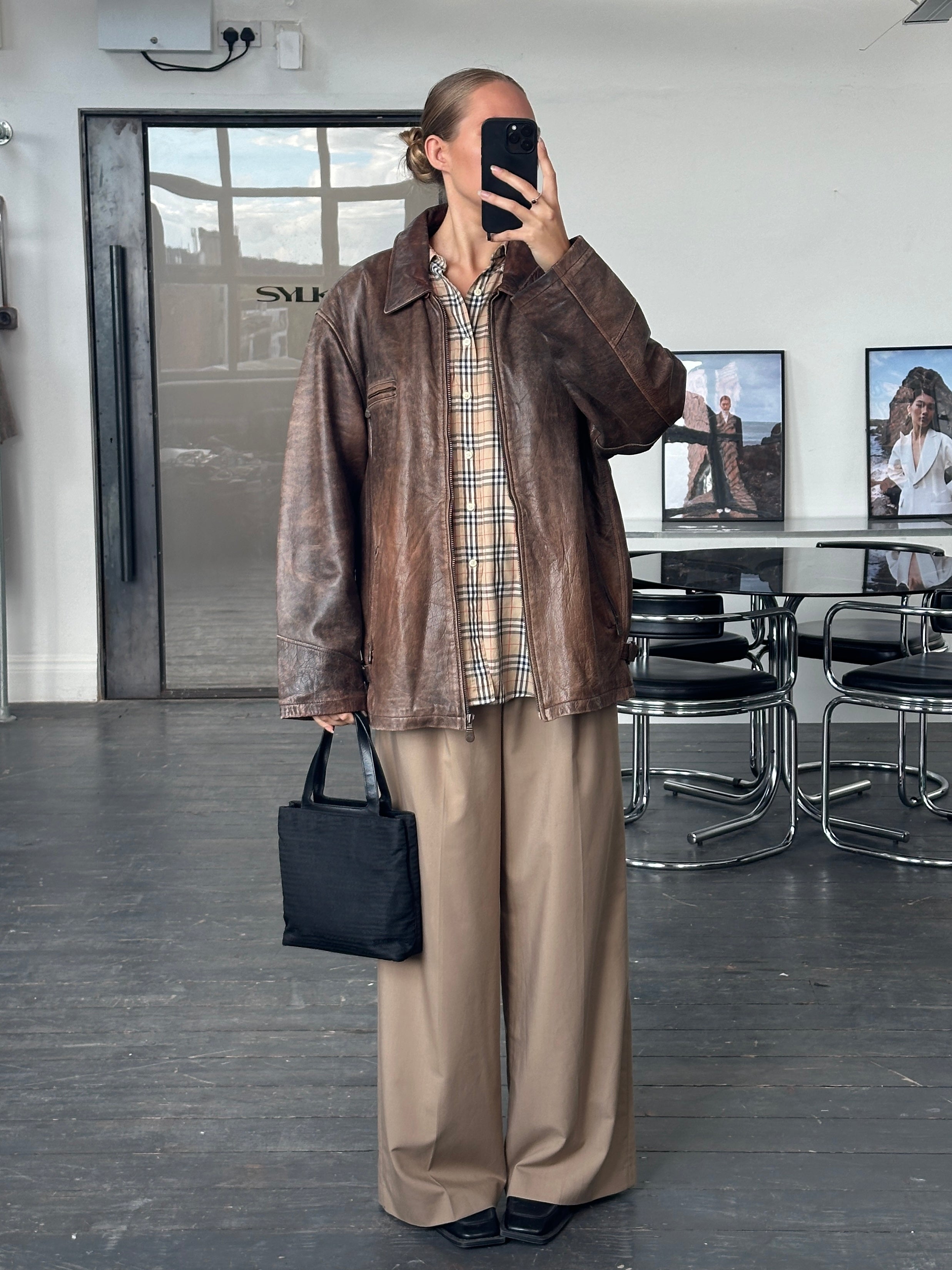 Vintage 1990s aged leather jacket, XL size, showcasing distressed brown leather with classic collar and front zipper.