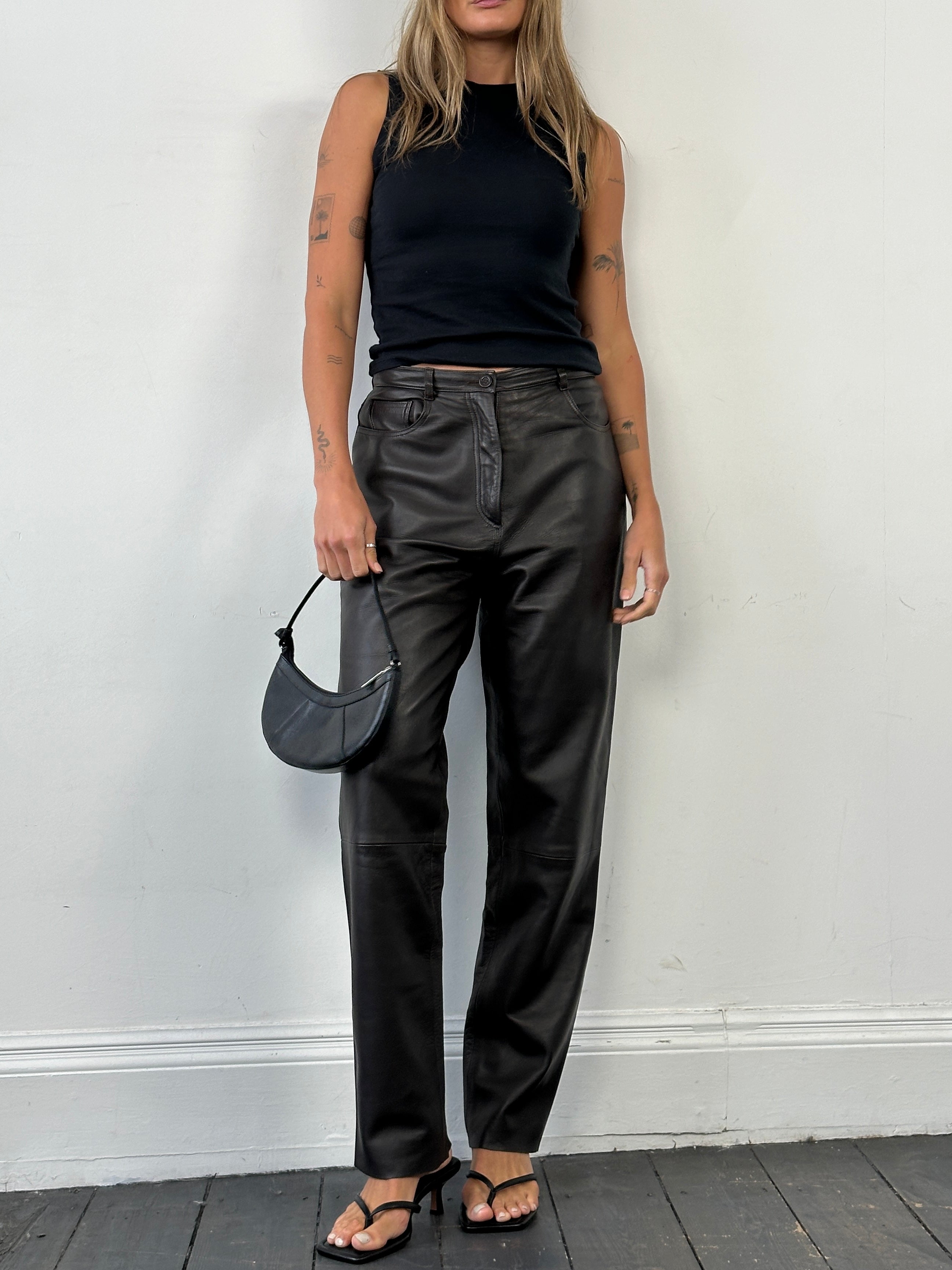 Jaeger 90s straight-leg leather trousers in size W30, showing the sleek black leather fabric and classic fit.