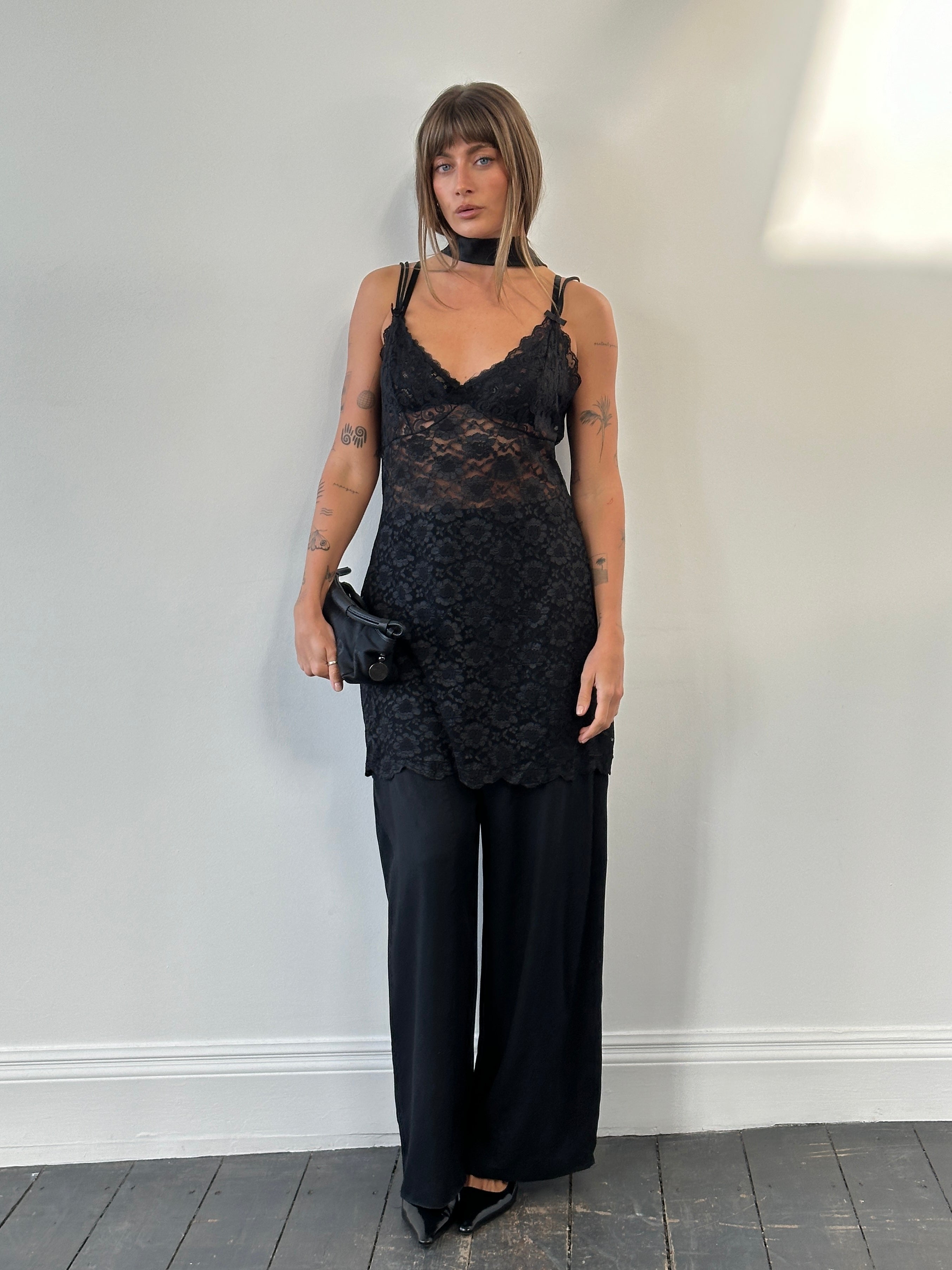 Vintage 1990s sheer lace mini slip dress in size large, featuring delicate lace detailing and a vintage-inspired design.