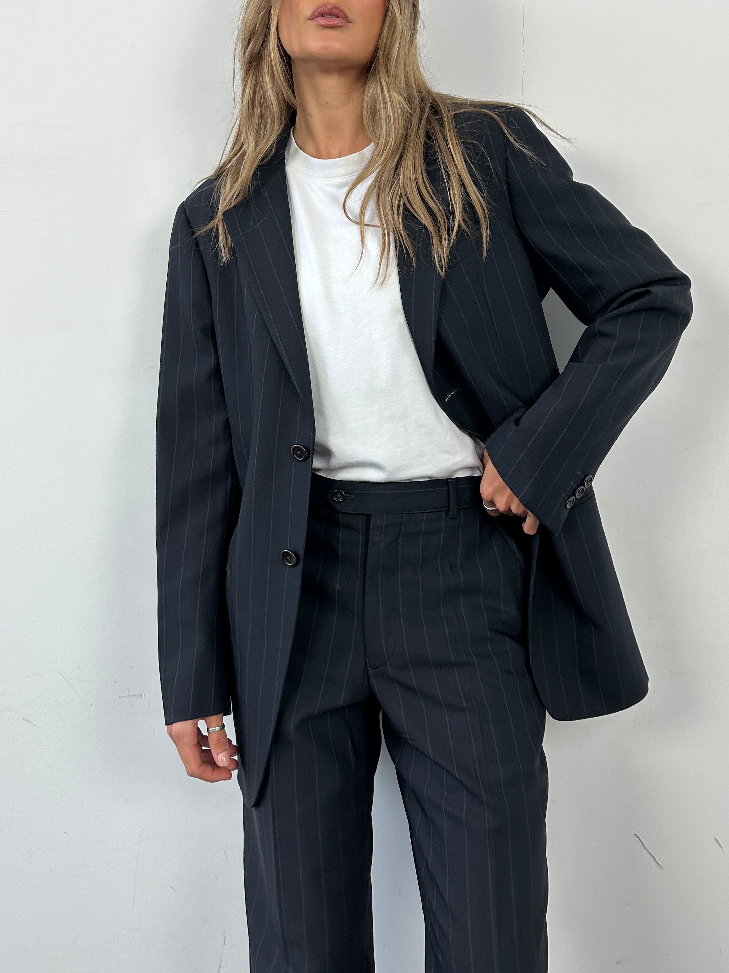Armani Collezioni pinstripe wool single-breasted suit in size 38R/W32, displayed as a stylish jumpsuit with tailored fit and classic design.