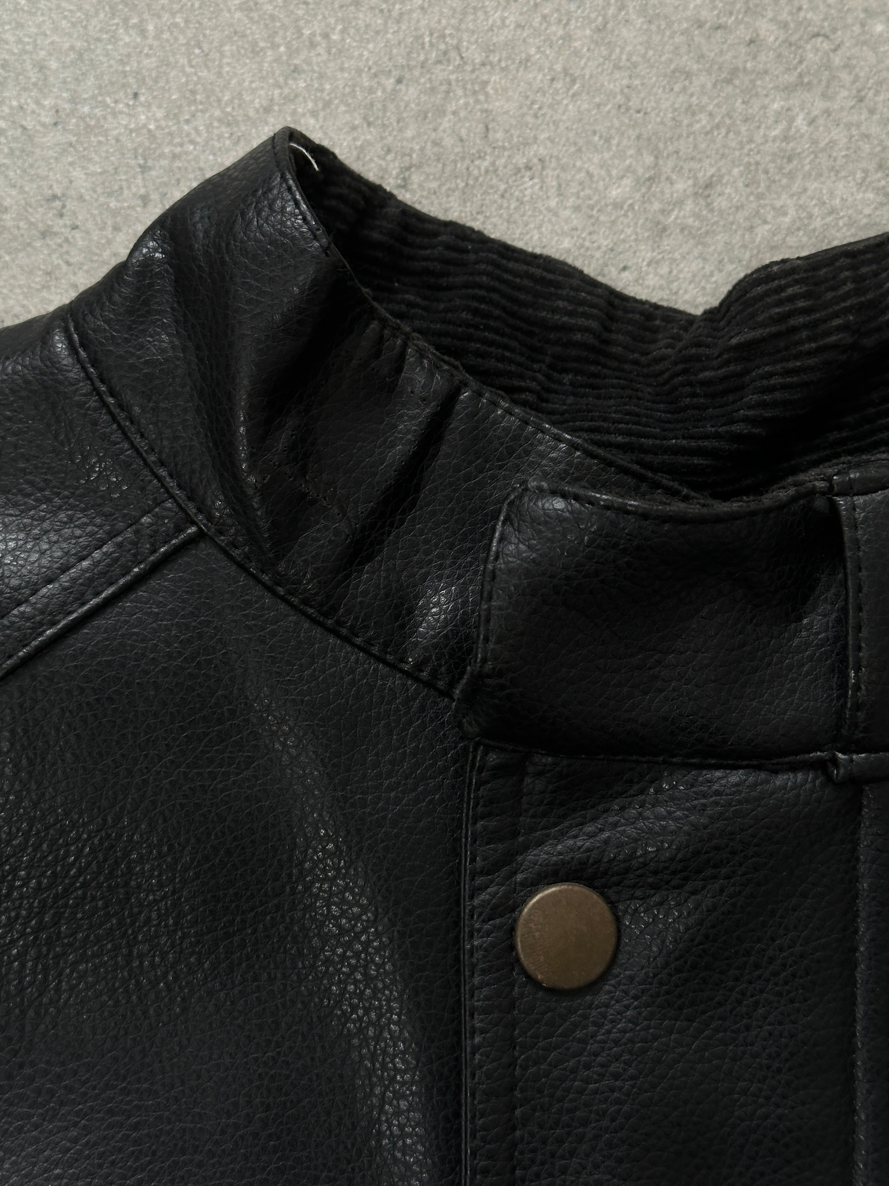 Vintage 1990s boxy faux leather jacket in size M, featuring classic black leather style and structured fit.
