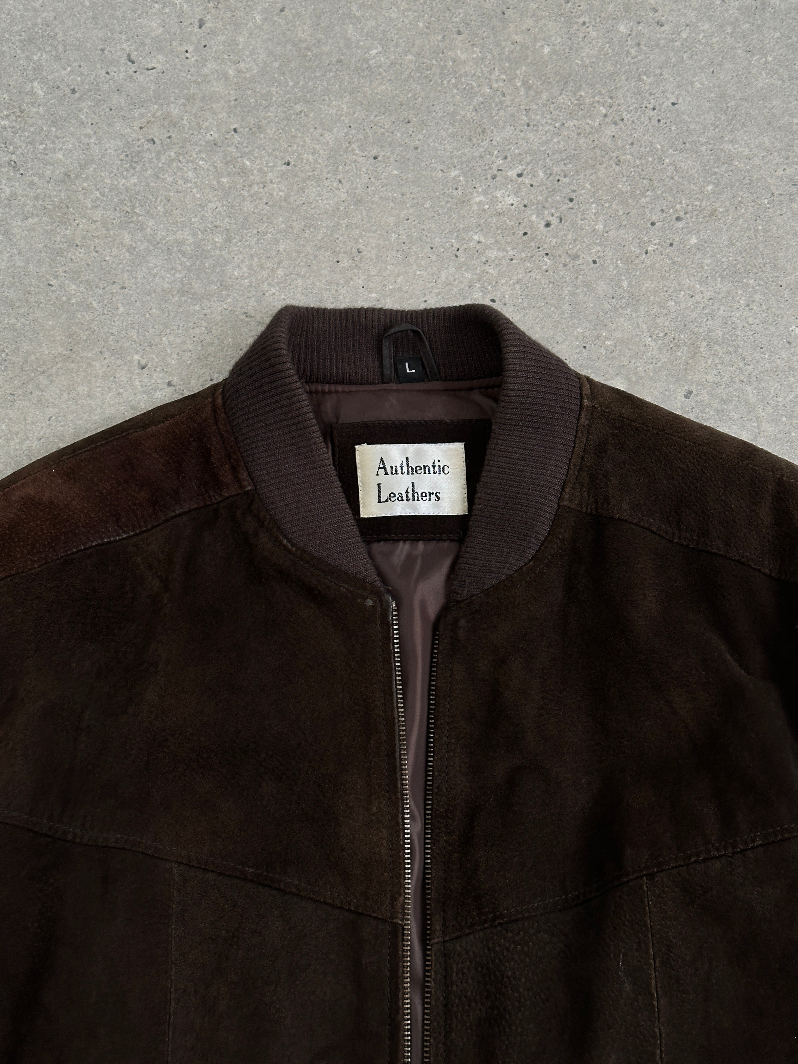 Vintage leather bomber jacket in suede, size large, featuring classic design and detailing, displayed on a neutral background.