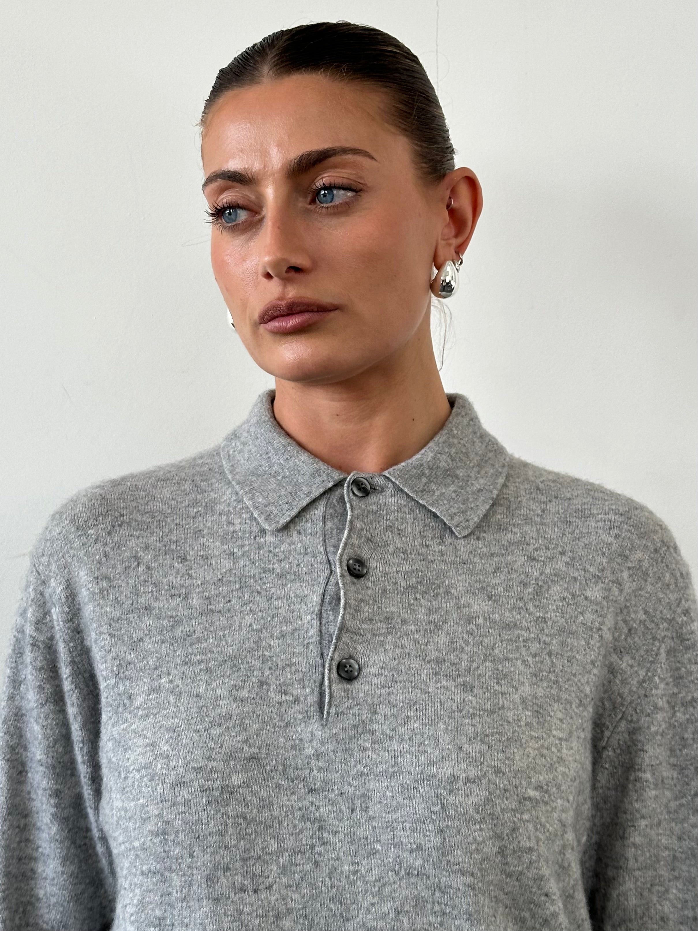 Vintage brand men's vintage merino wool cashmere polo jumper, in size M, displayed on a hanger showing the knit texture and collar.