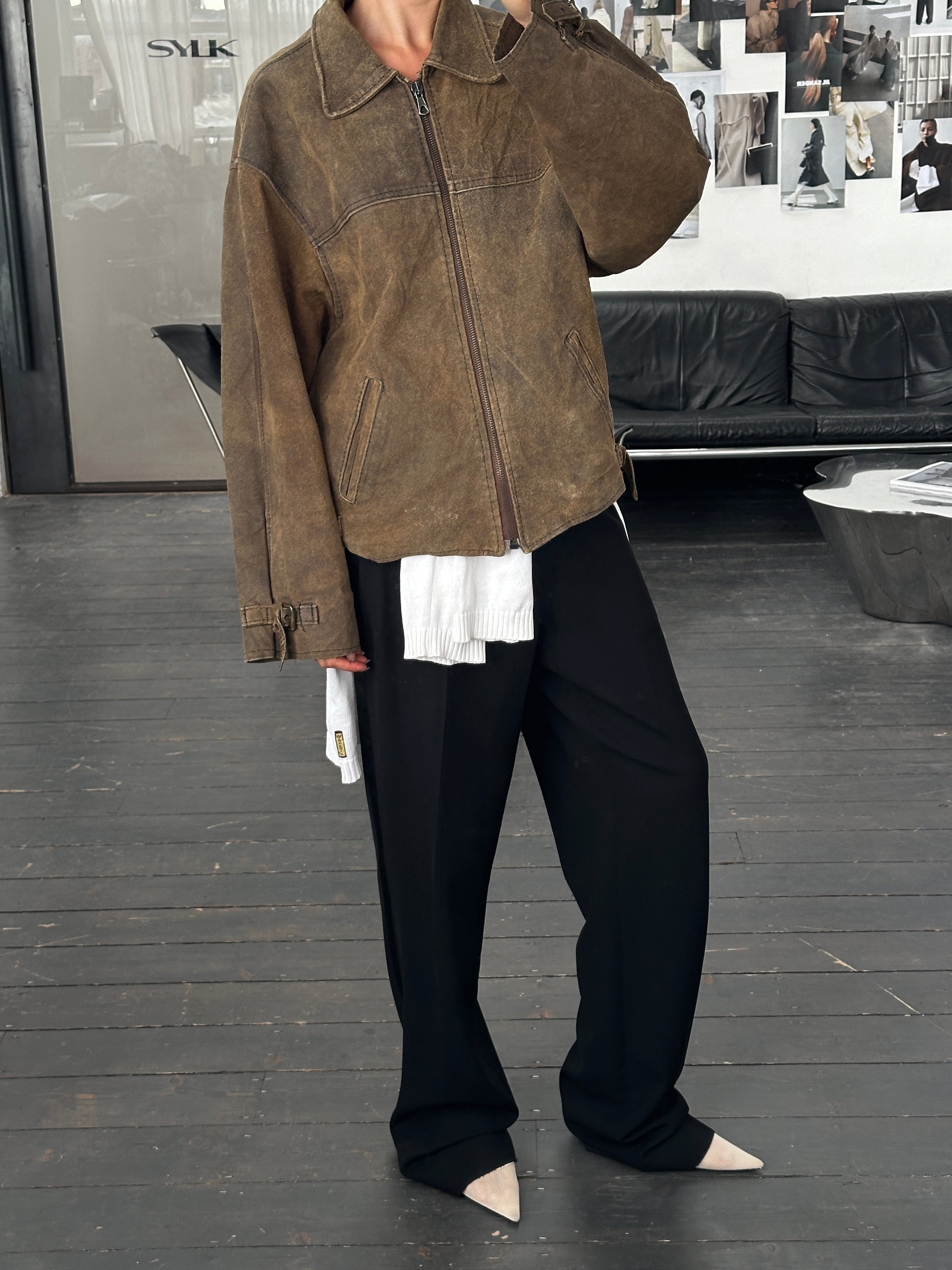 Vintage 1980s boxy leather jacket in XL, featuring classic design and rich leather texture, displayed on a hanger.
