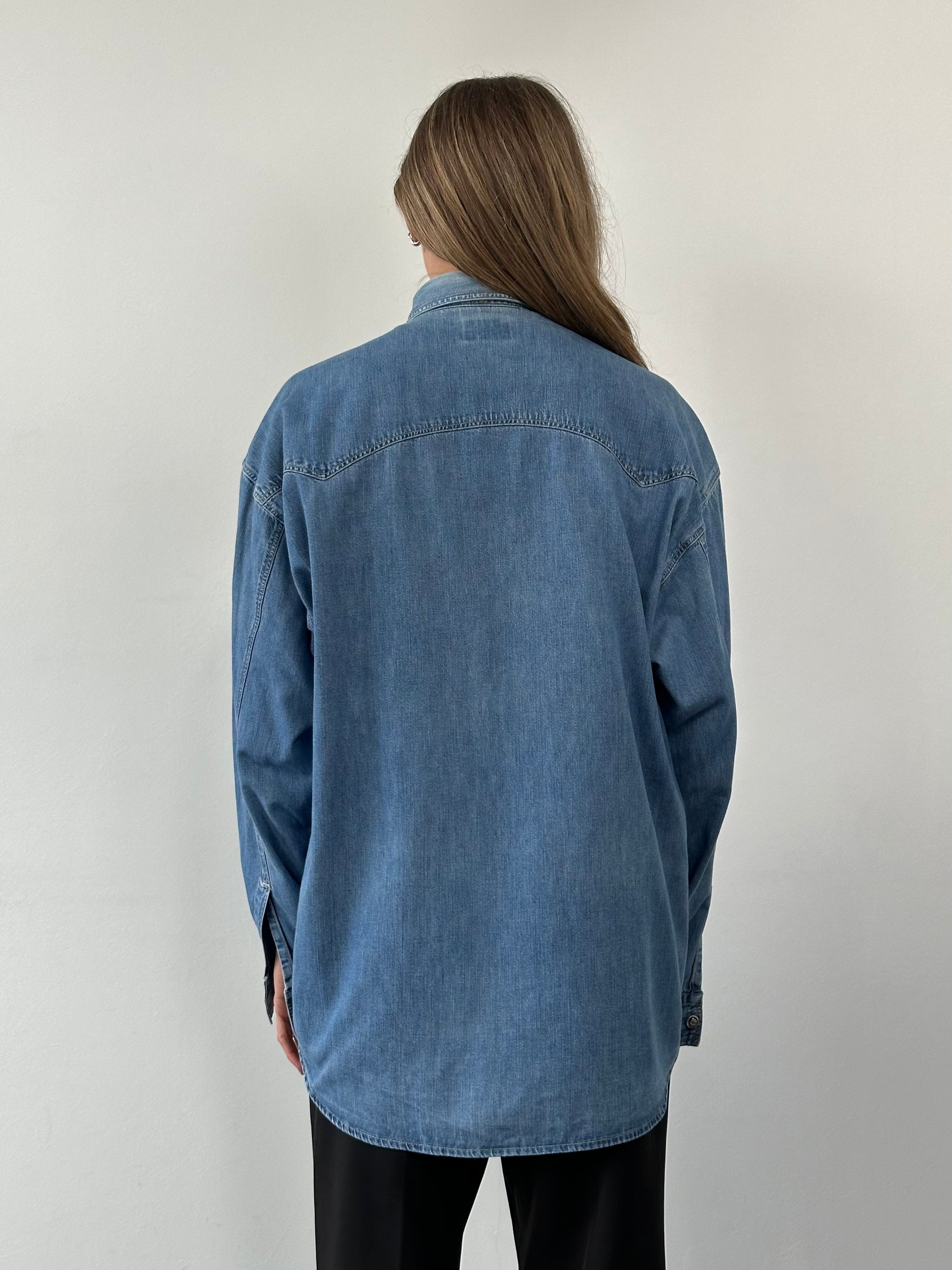 Versace Medusa button denim shirt in XL, featuring classic denim fabric and Medusa logo buttons, displayed on a hanger.