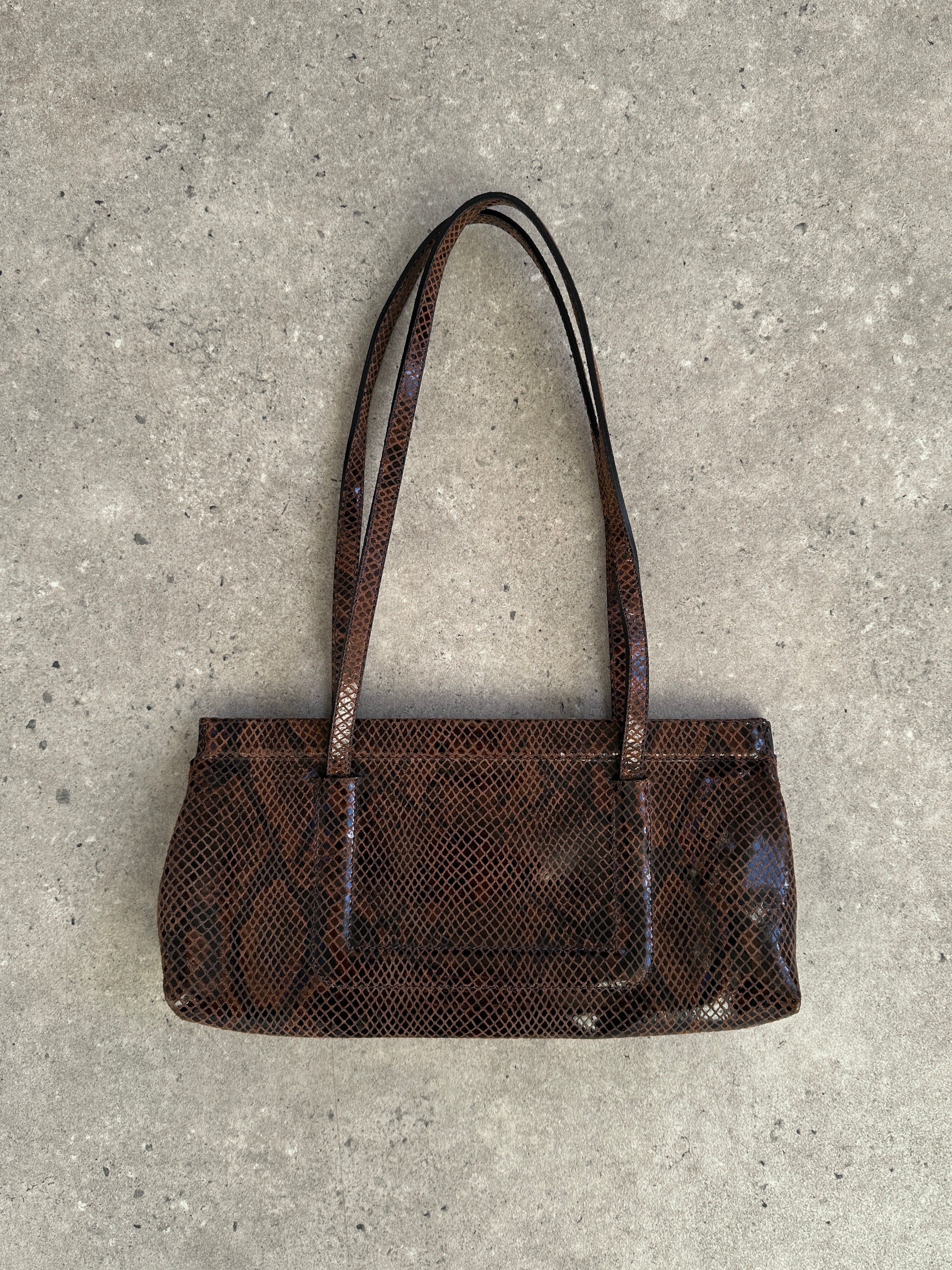 Emporio Armani snakeskin handbag with gold-tone hardware, featuring a sleek rectangular shape and elegant design.