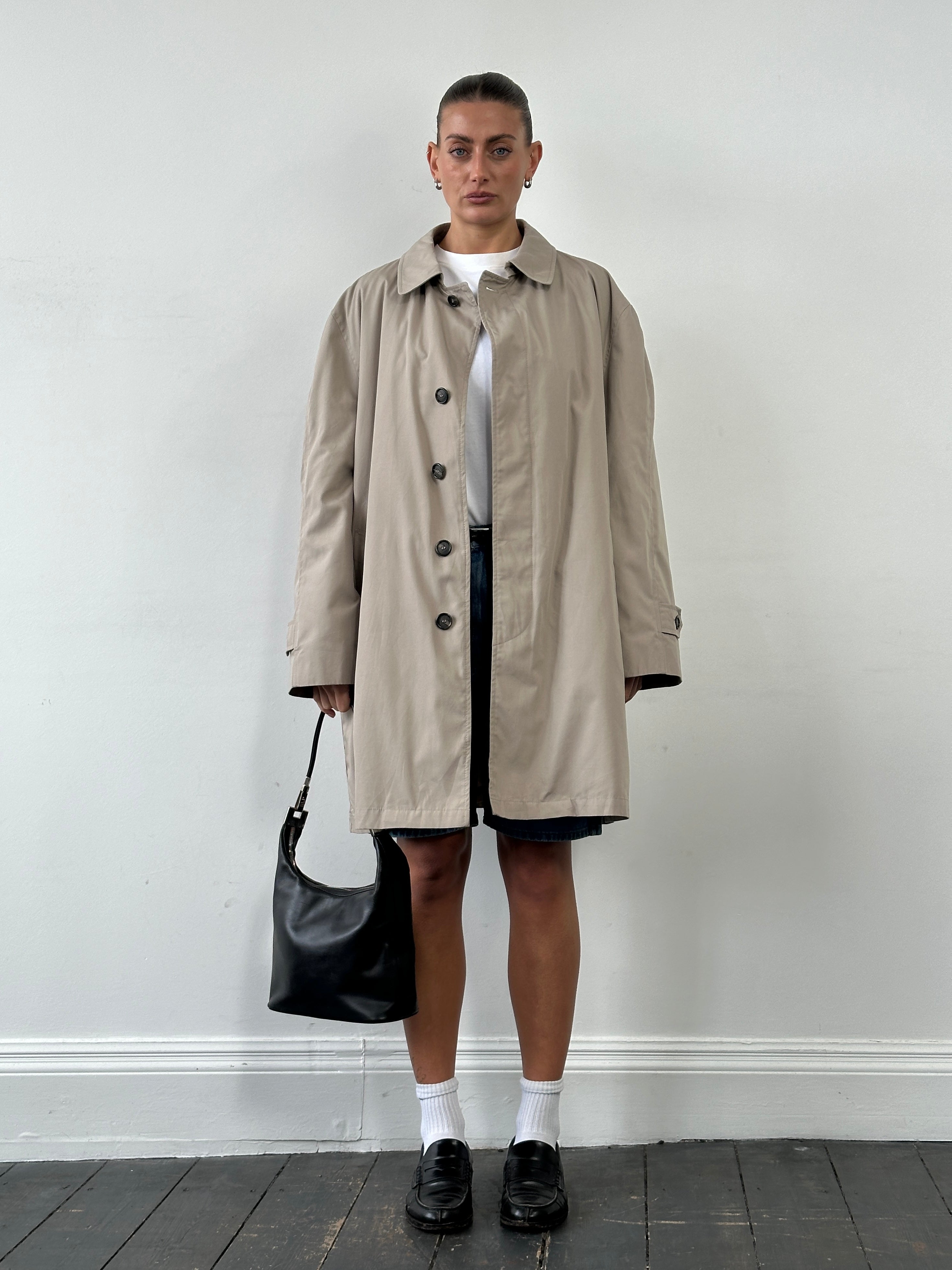London Fog 1990s cotton single-breasted trench coat in XL, shown hanging with classic beige color and waist belt details.