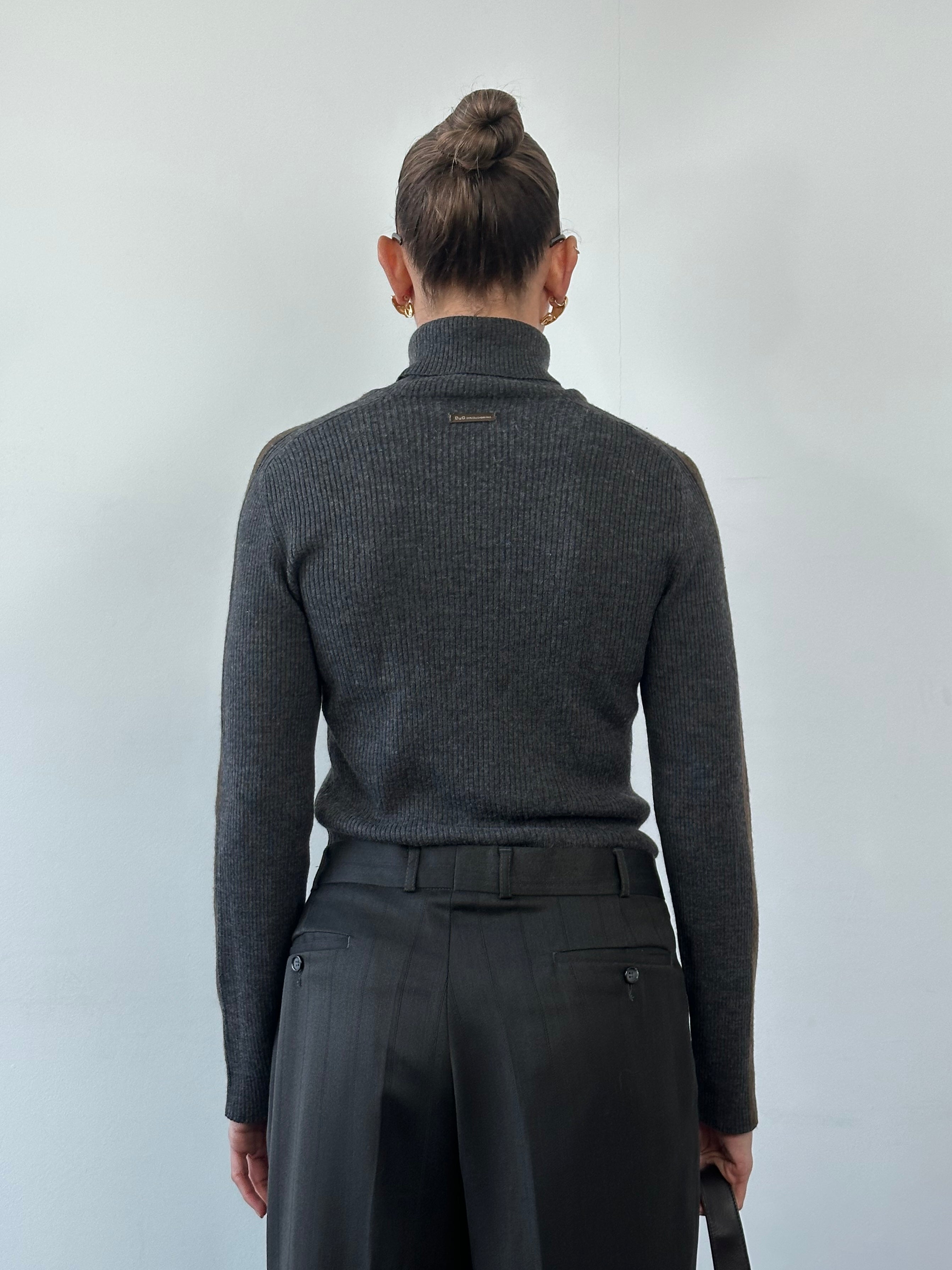 Dolce & Gabbana wool rib knit turtle neck jumper in size M, close-up of black textured knit fabric and high neckline.