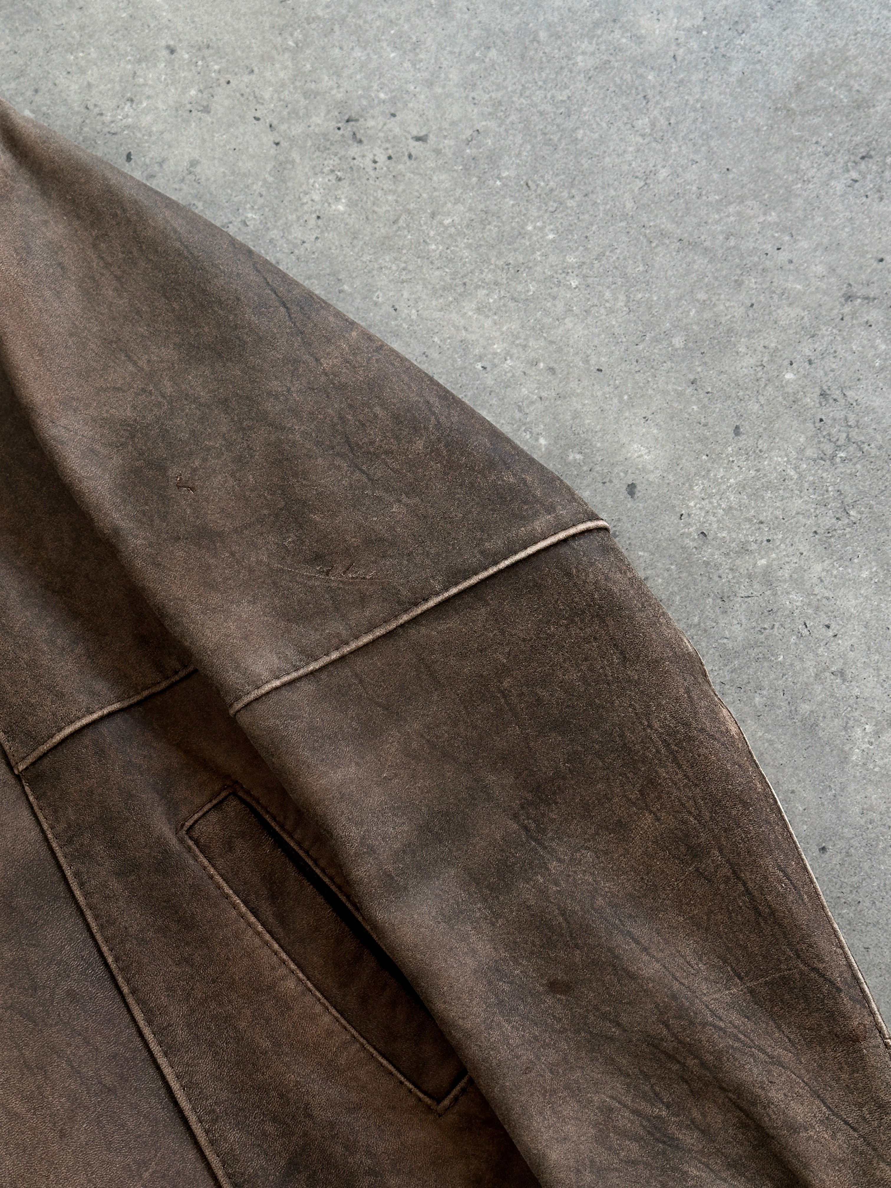 British Vintage aged leather biker jacket in size M/L with classic design and rugged texture, featuring metal hardware and detailed stitching.