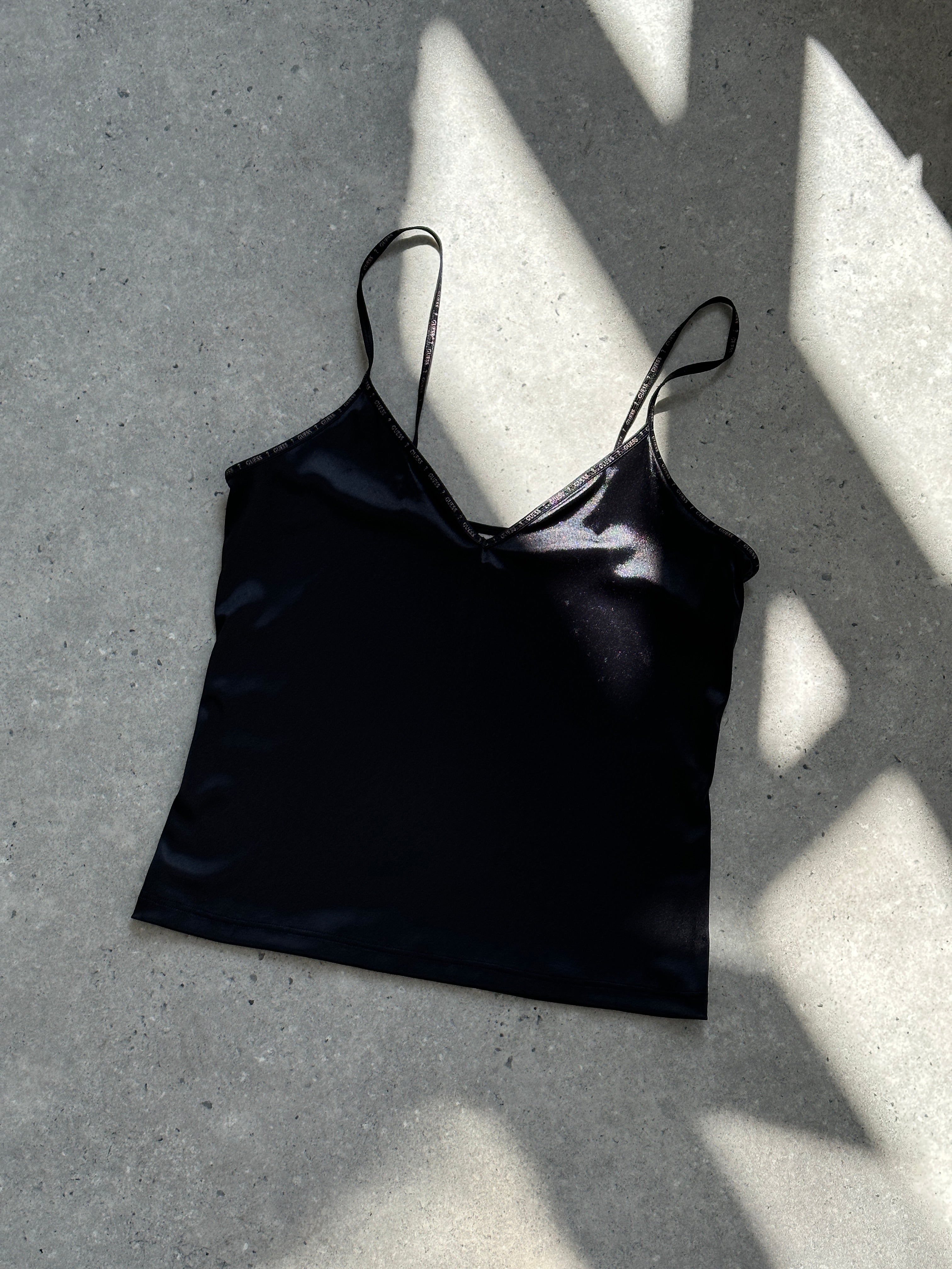 Guess stretch spaghetti cami top in black, fitted design with thin straps, perfect for casual or layered outfits.