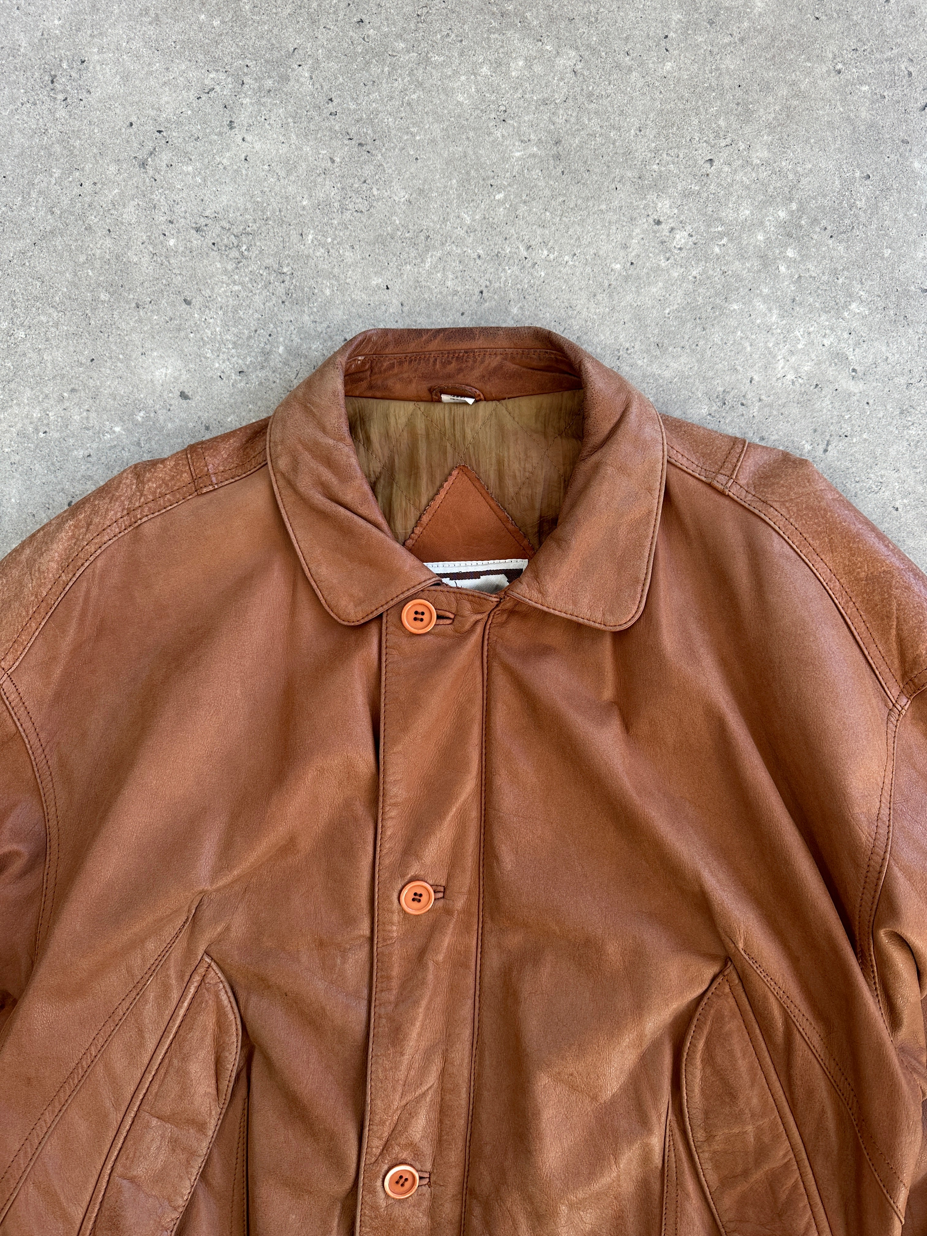 Vintage 1980s leather bomber jacket in size large, featuring classic design with a worn leather finish and ribbed collar.