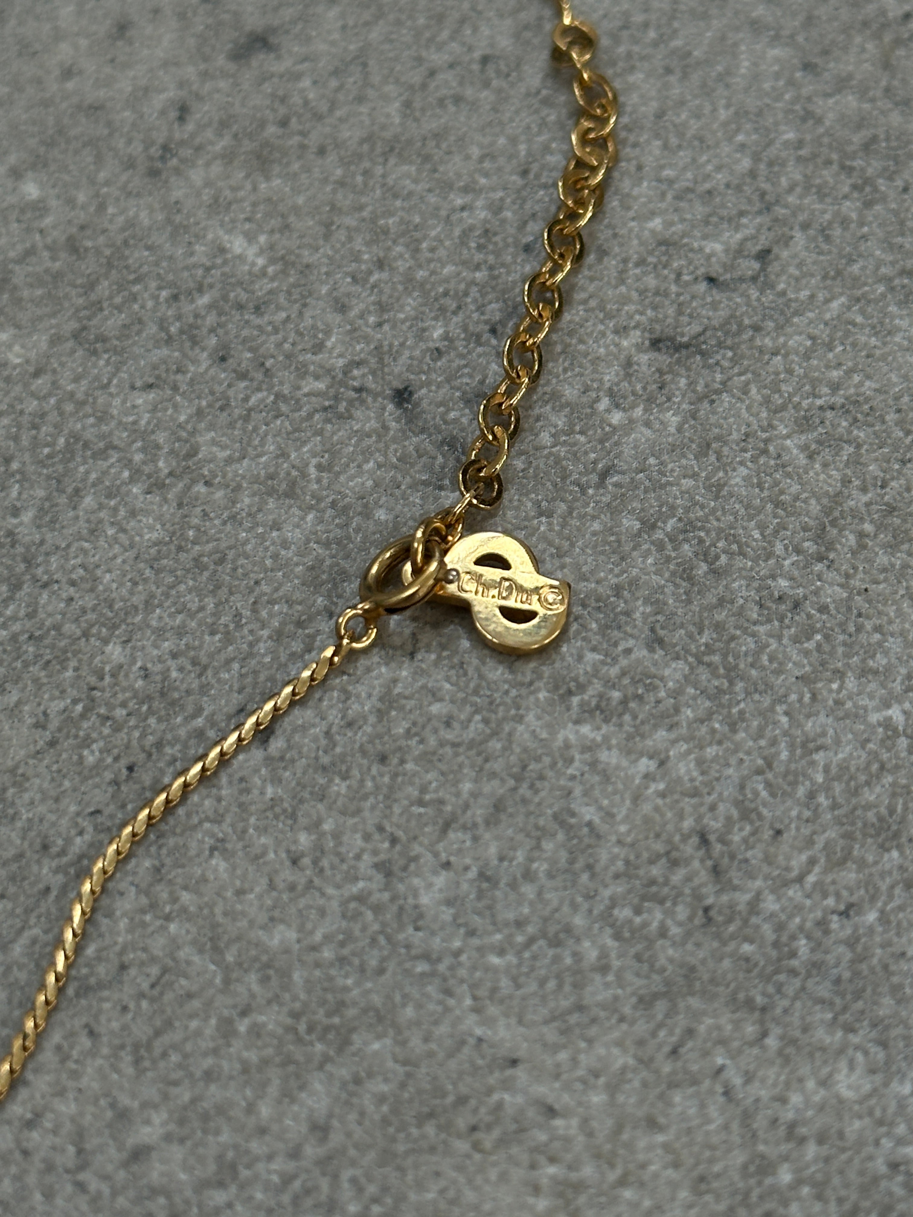 Christian Dior 16-inch gold plated logo pendant necklace with chain and brand emblem, elegant and stylish jewelry accessory.