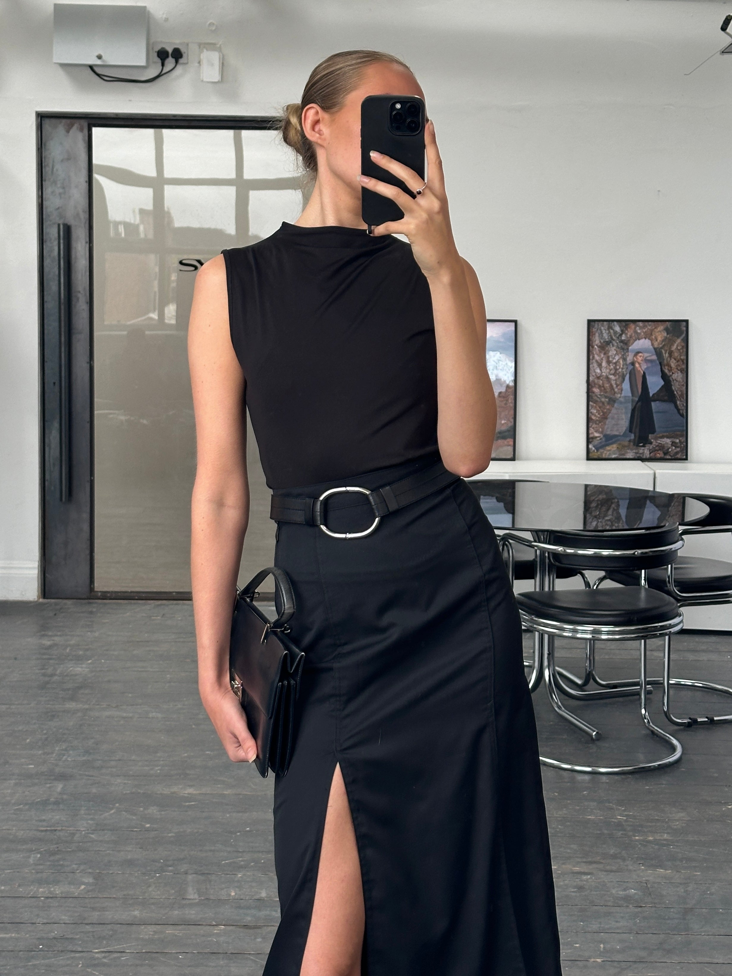 Vintage 1990s pleated midi skirt in neutral tones, showcasing classic high-waisted design and flowing fabric.