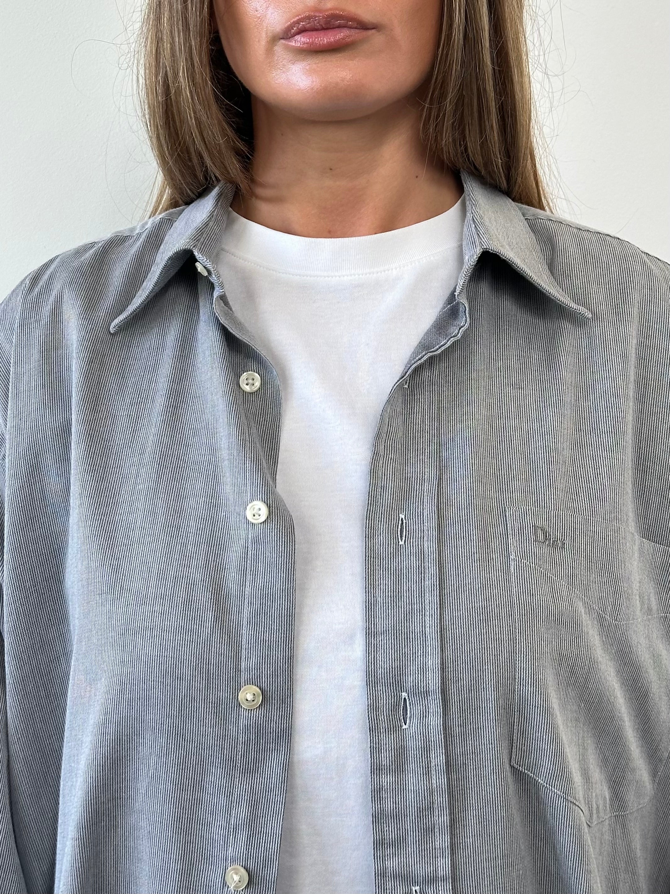 Christian Dior cotton logo shirt in size L/XL, featuring the iconic Dior branding and classic design, displayed on a hanger.