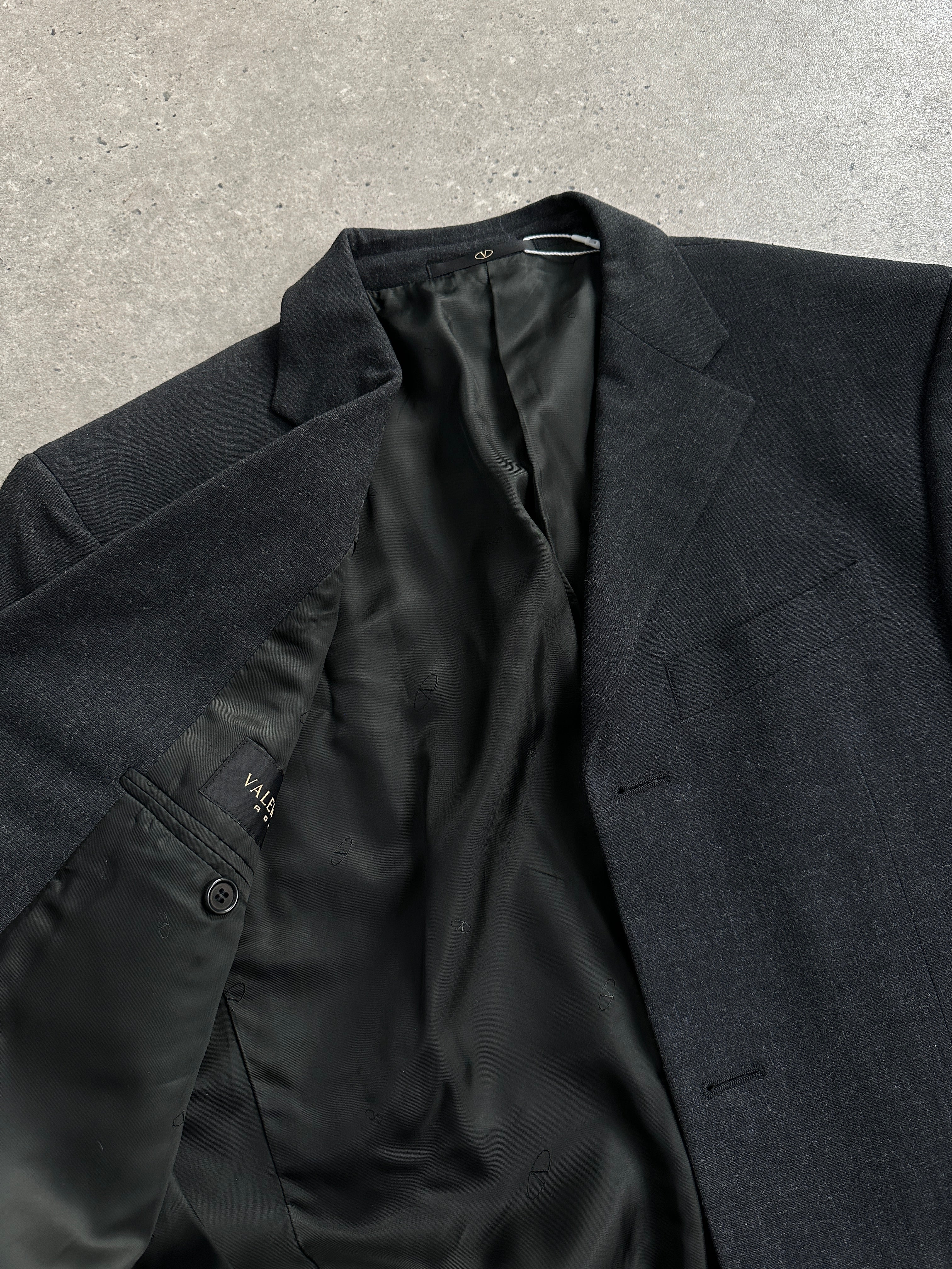 Valentino wool single-breasted blazer in size 36R/M, tailored fit, navy color, with notch lapel and classic button closure.