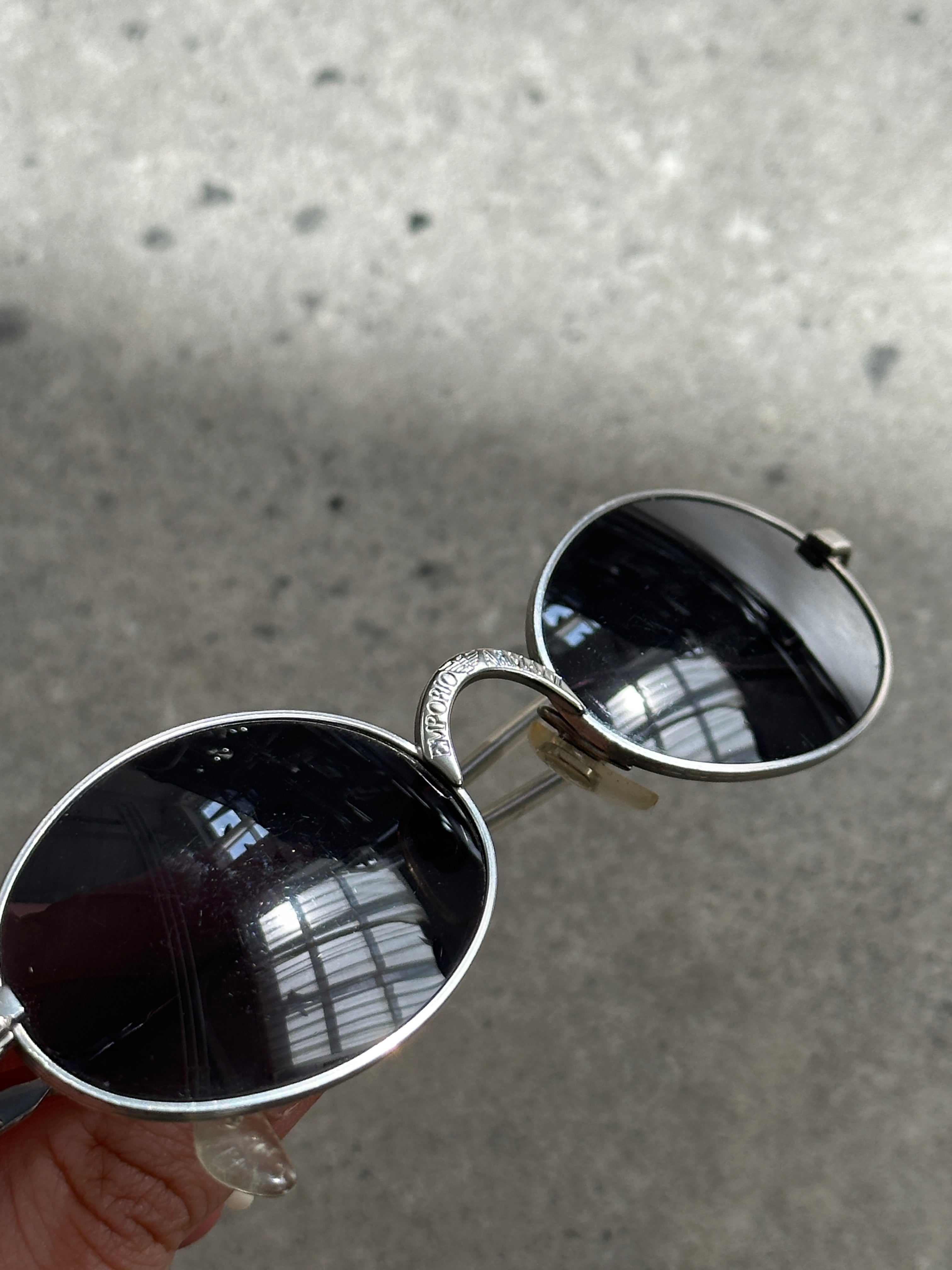Emporio Armani metal oval sunglasses with sleek frames and dark tinted lenses, stylish and lightweight eyewear.