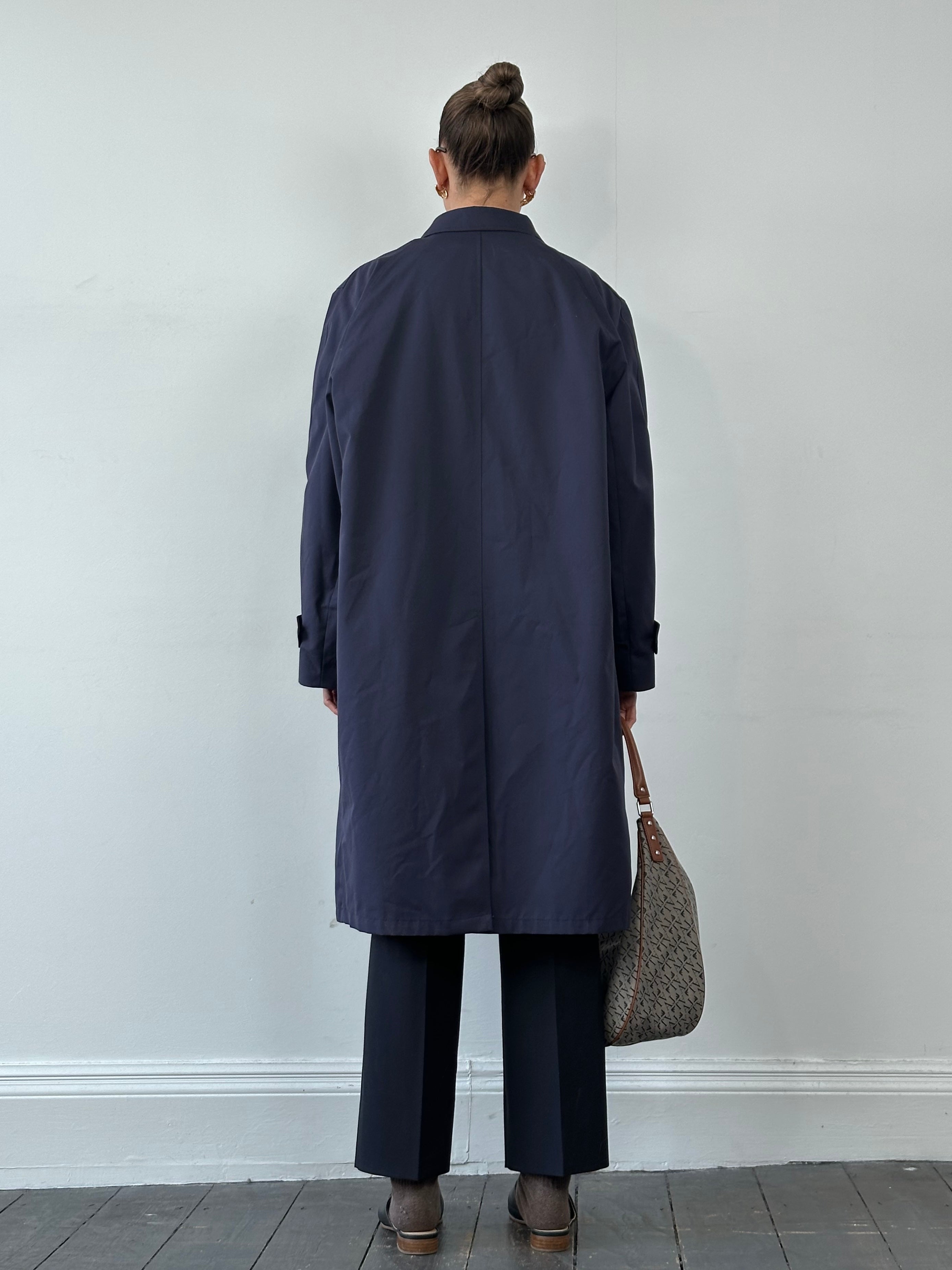 London Fog XL trench coat with concealed placket, classic double-breasted design, and belted waist in neutral fabric.