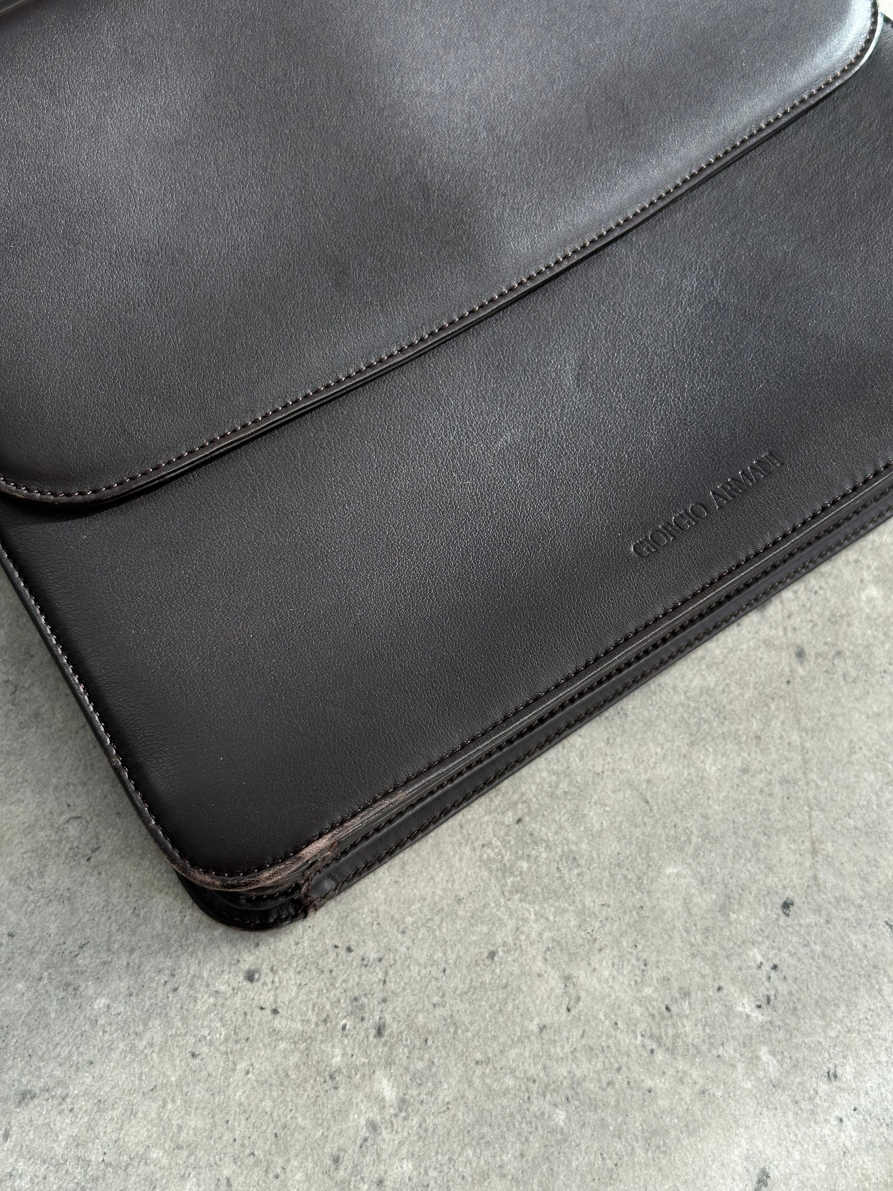Giorgio Armani Le Collezioni leather shoulder bag with sleek design and adjustable strap, displayed on a neutral background.